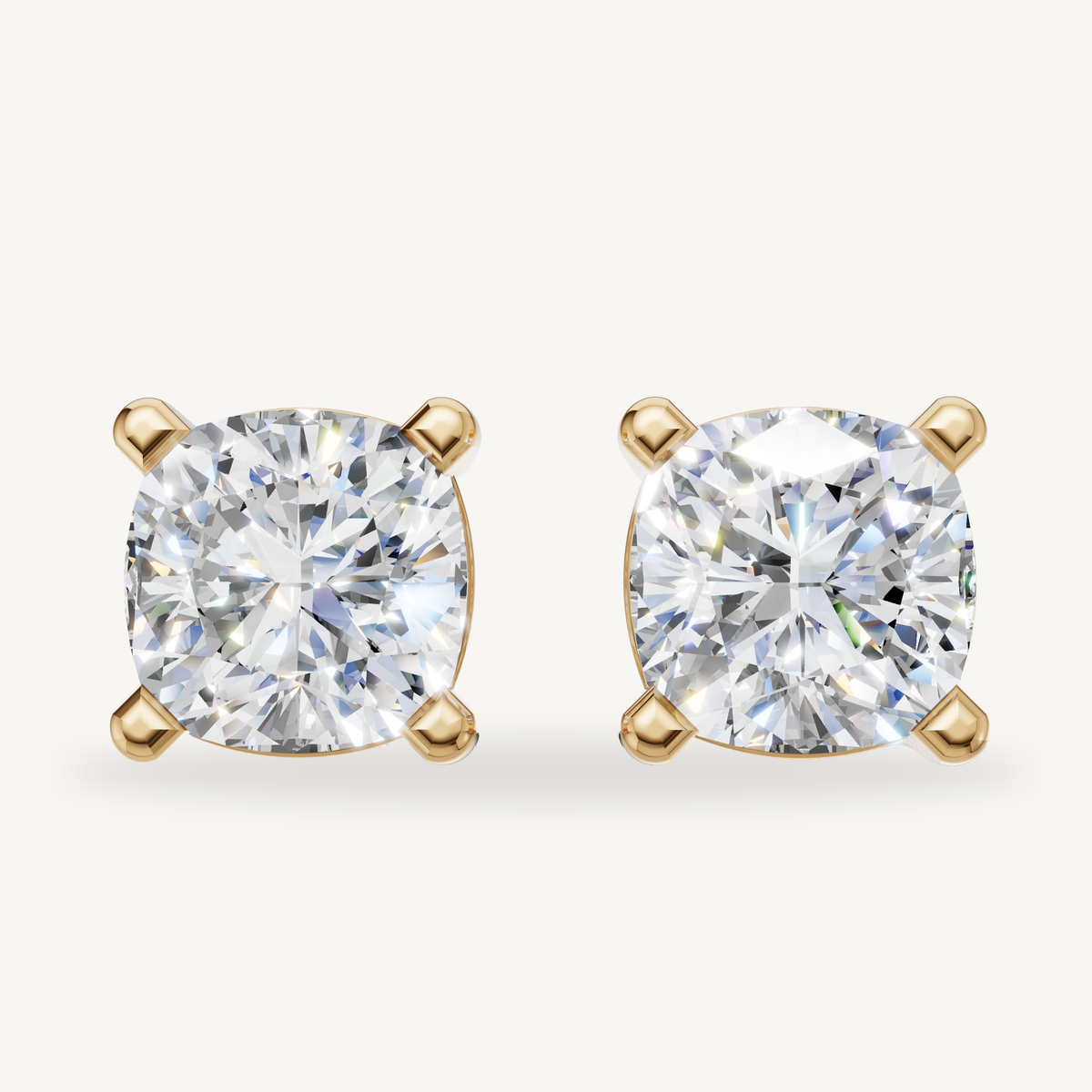 Cushion cut lab grown diamond stud earrings in 14K yellow gold by Raul Diamonds