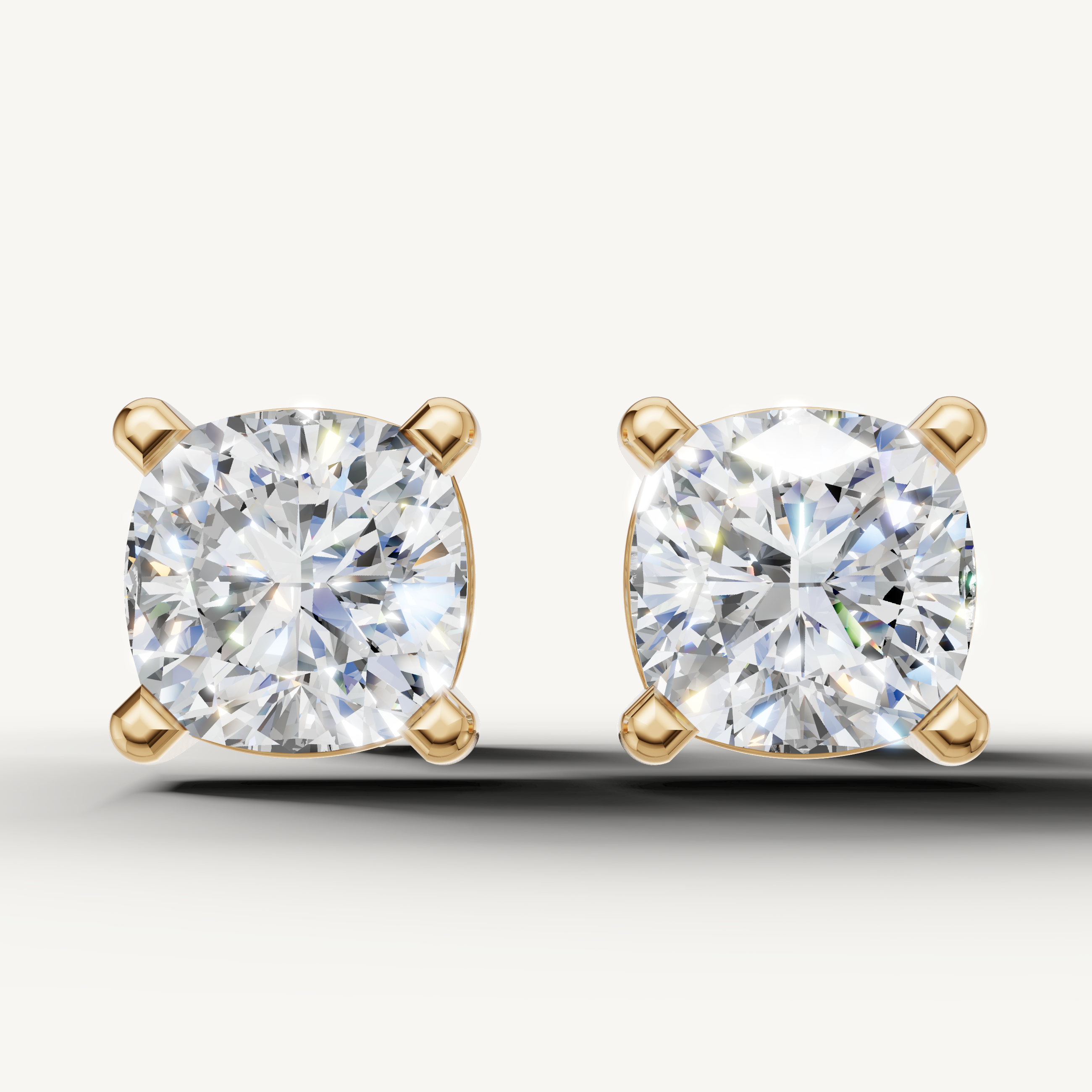 Cushion cut lab grown diamond stud earrings in 14K yellow gold by Raul Diamonds