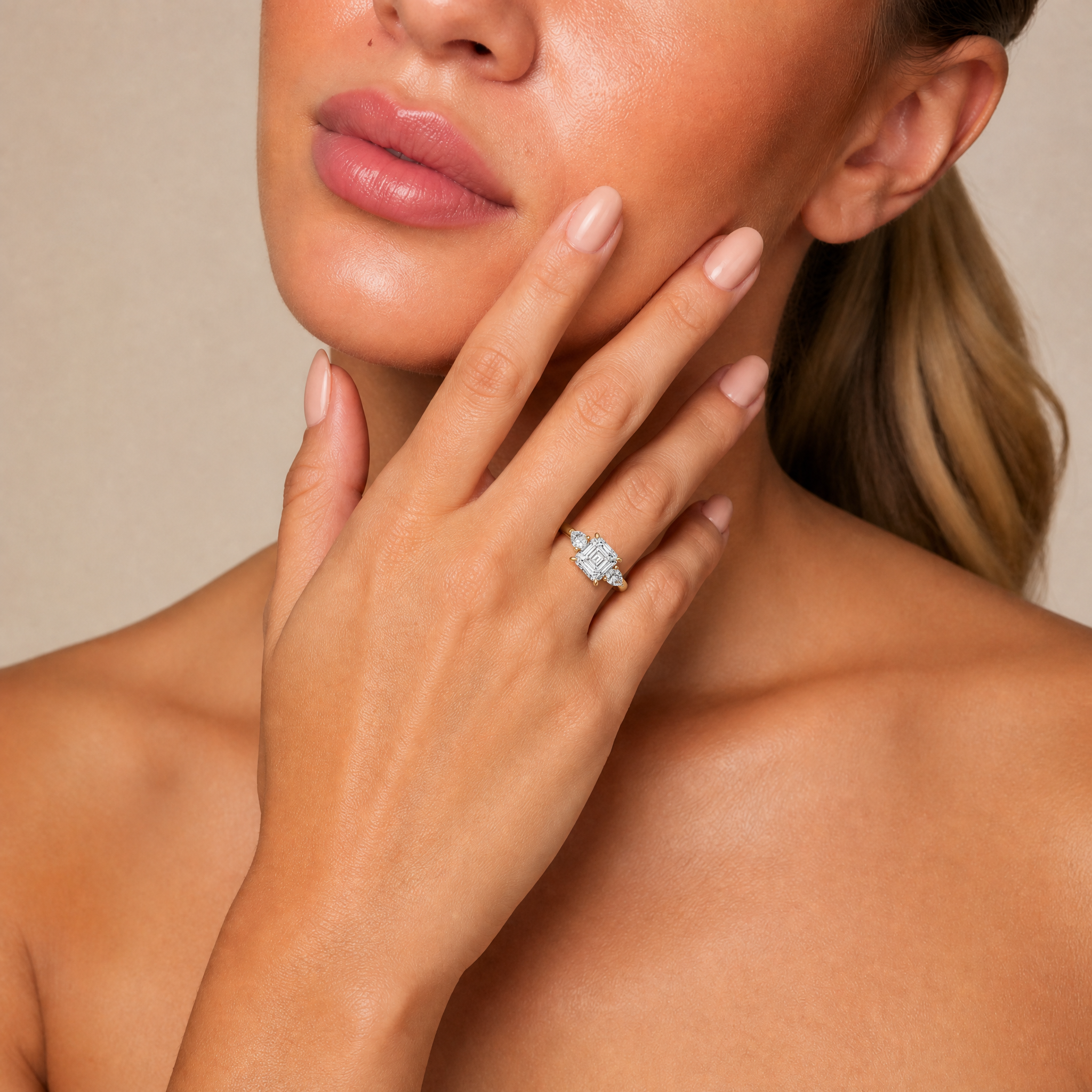 Model wearing Raul Diamonds Elara Asscher cut three-stone engagement ring in 18k gold