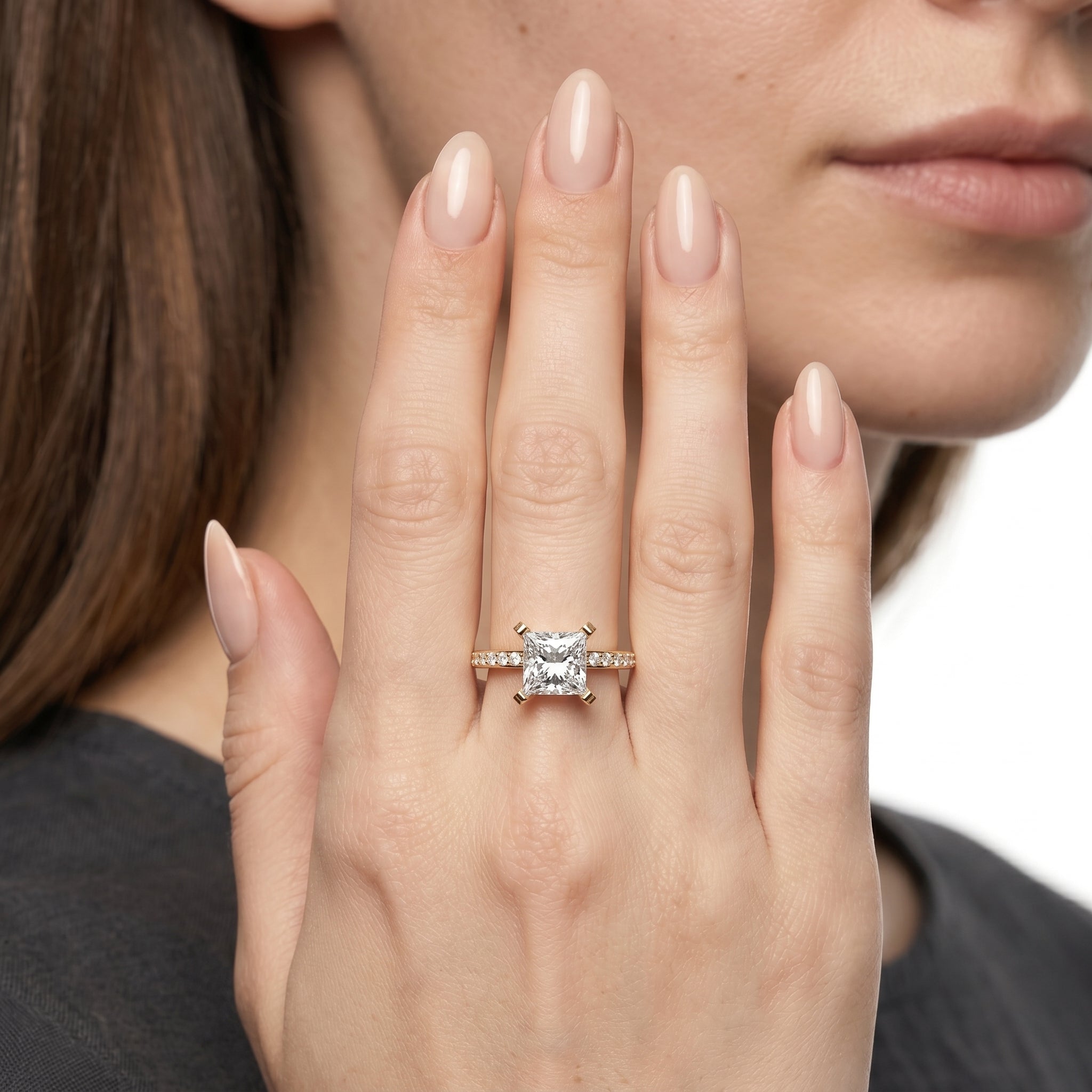 A professional close-up shot of the Sovereign Princess ring by Raul Diamonds, showcasing a high-carat princess cut diamond center with shimmering pavé accents on a luxury gold band.