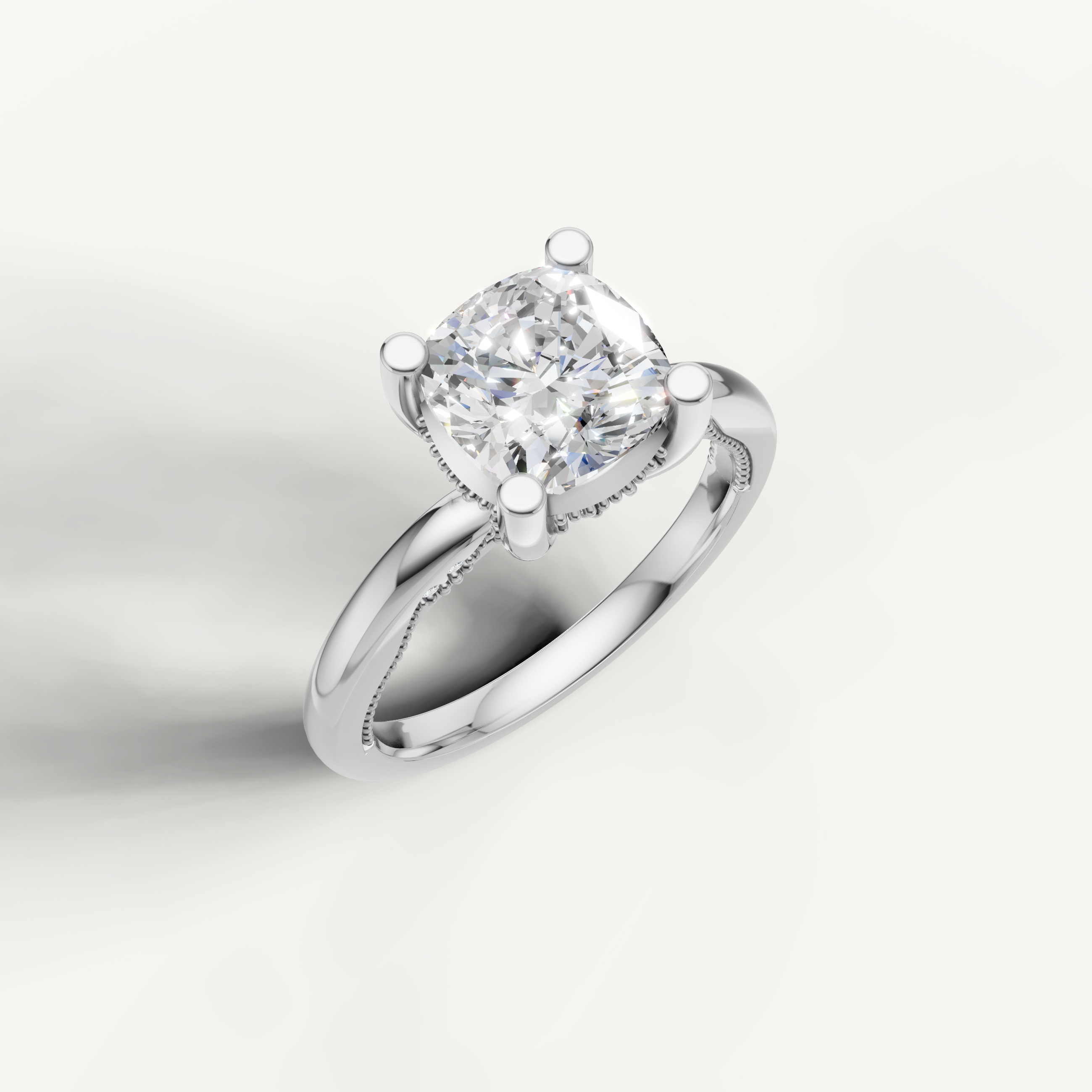 A bright, silvery-white engagement ring showcasing a prominent cushion-cut center stone on a smooth, rounded band.