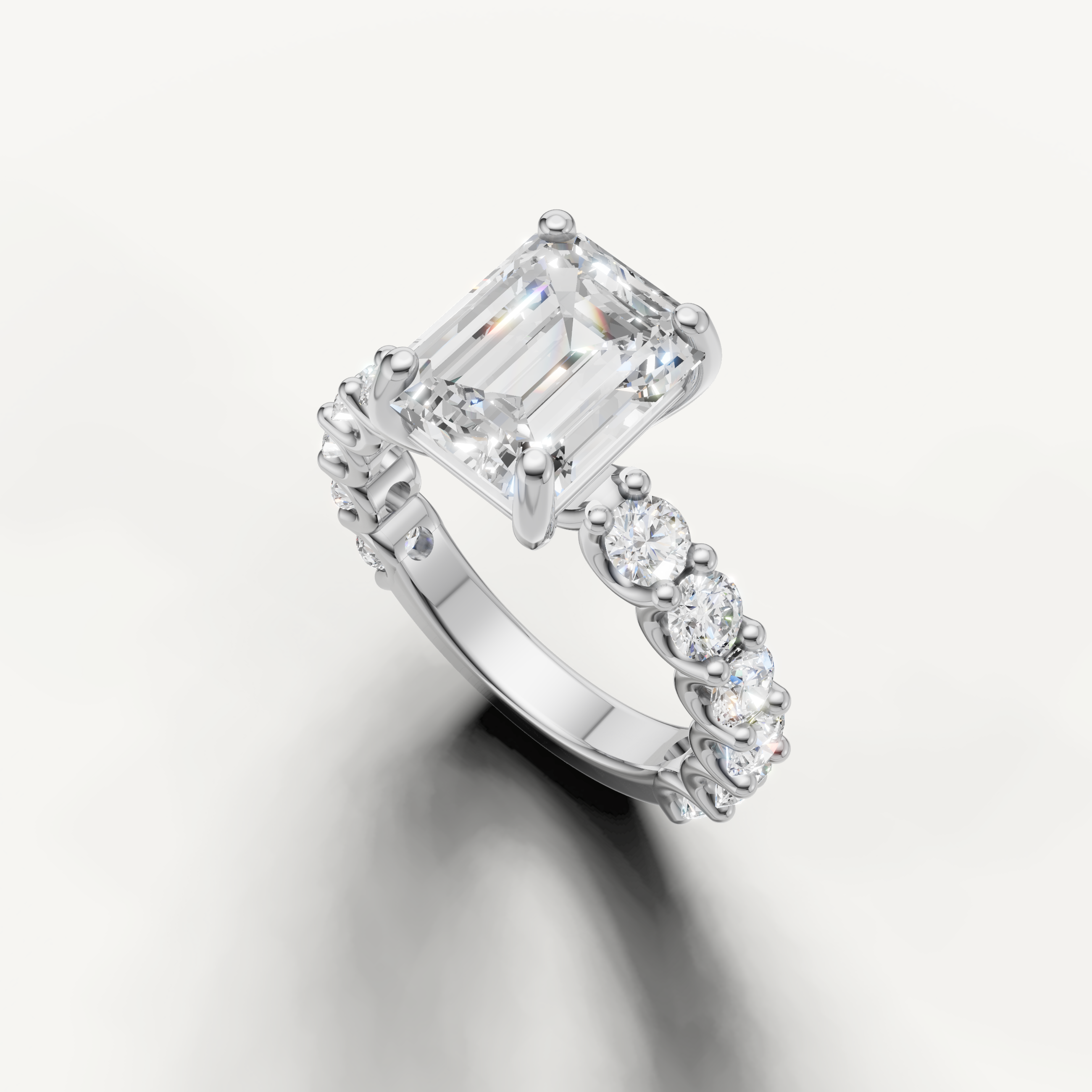 Emerald cut diamond ring with graduated side stones shared prong setting white gold