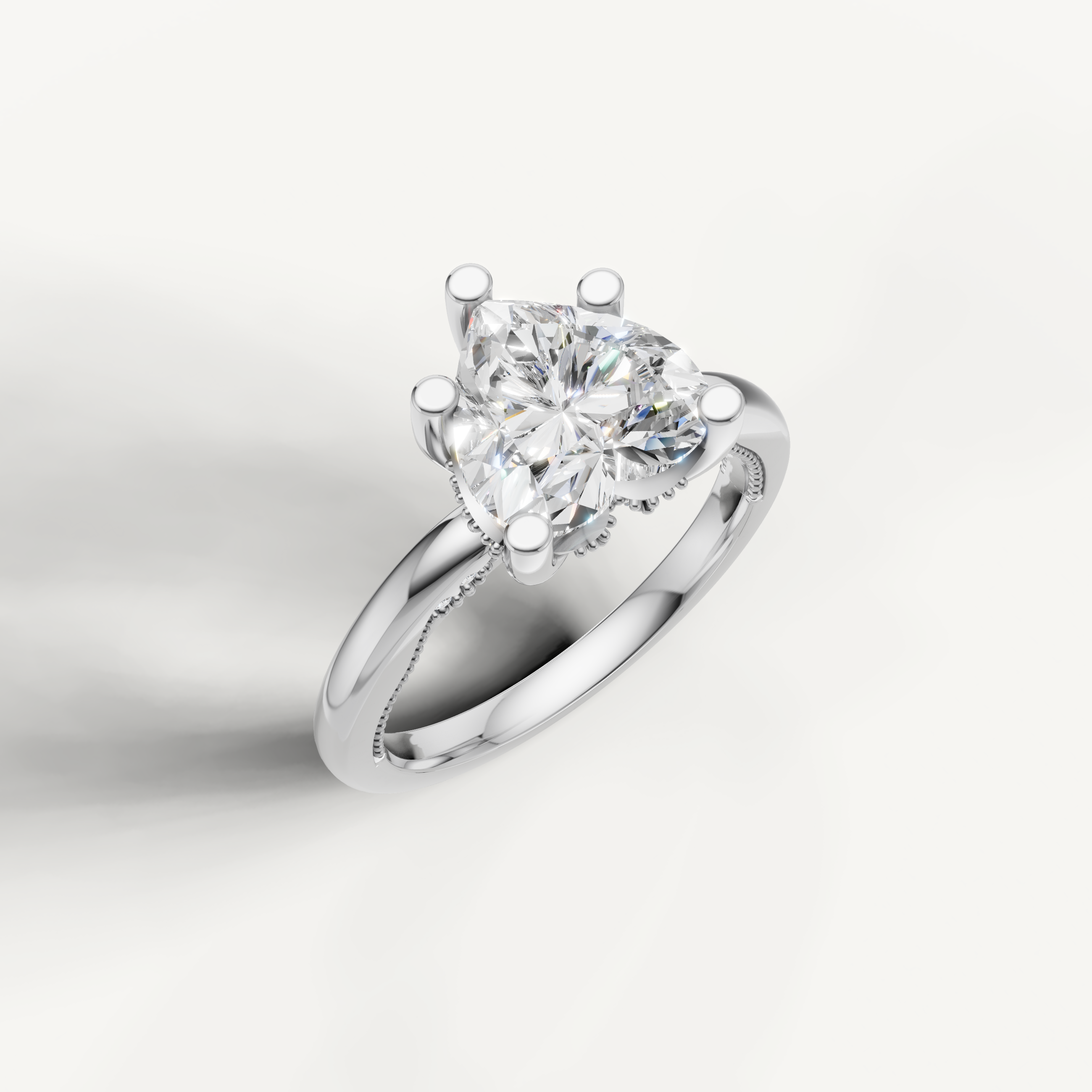 A sleek, silvery-white band holding a prominent heart-cut center stone, designed for a clean, elegant, and romantic profile.