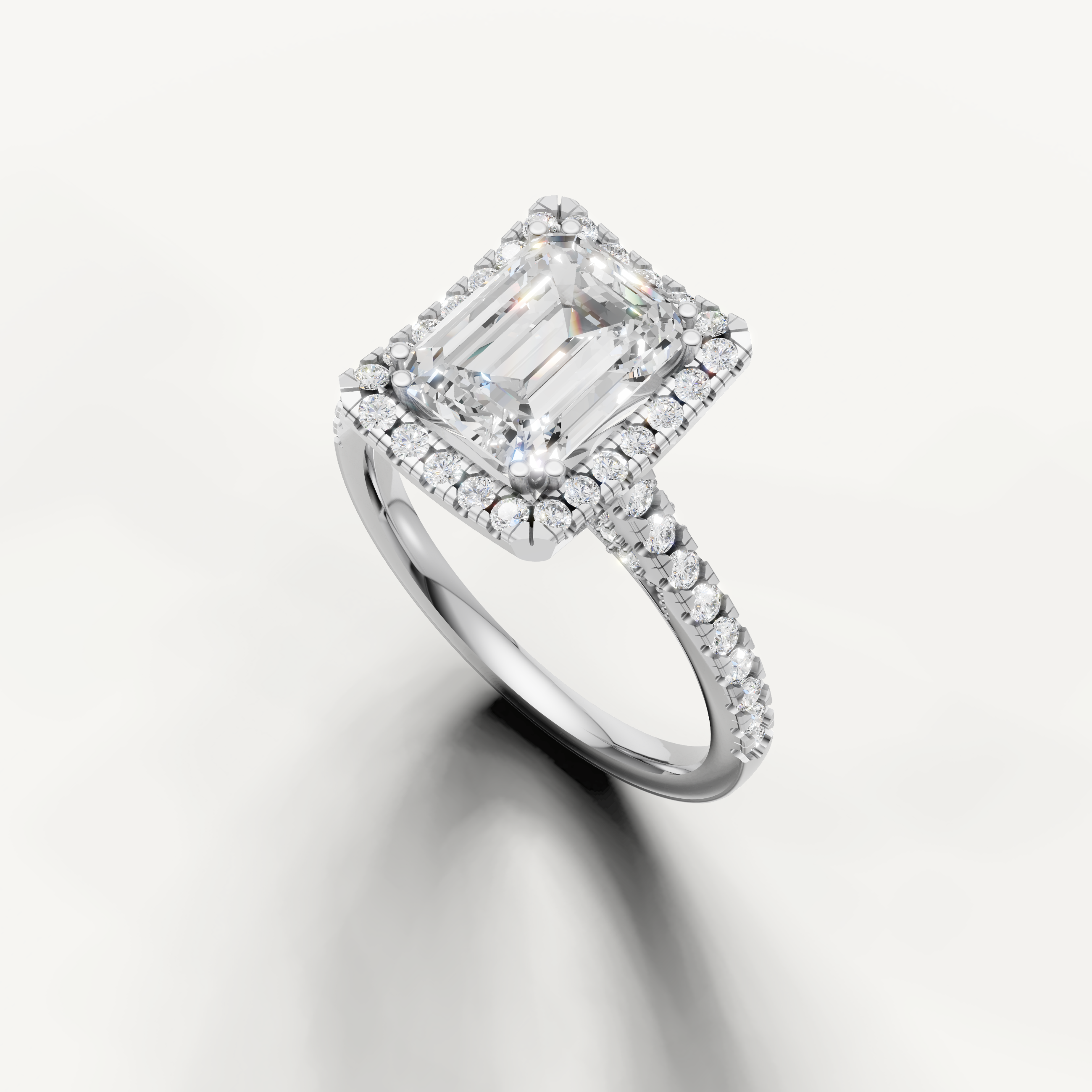 White gold emerald cut lab grown diamond ring featuring a timeless halo setting and sparkling pavé band