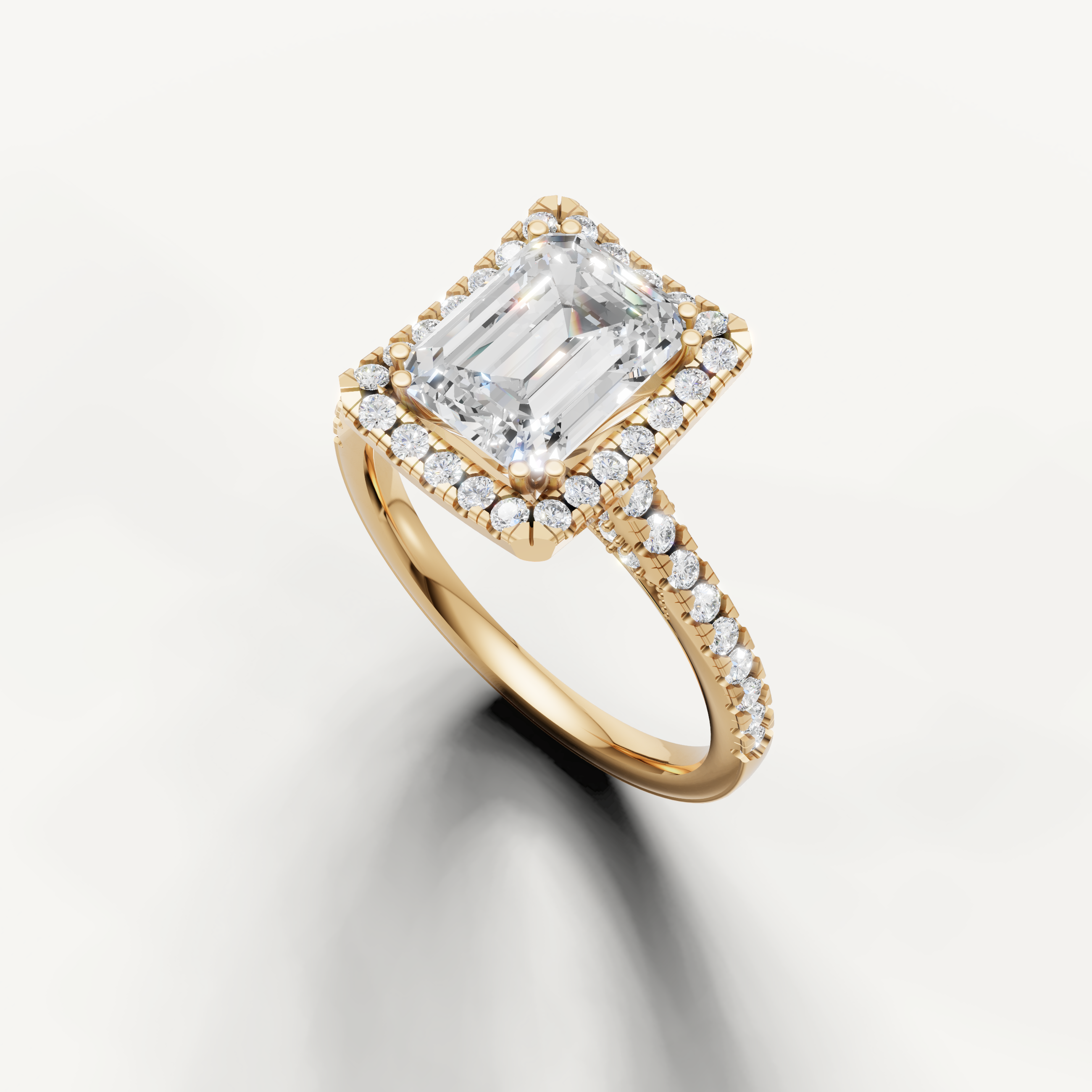 Yellow gold emerald cut lab grown diamond ring featuring a classic halo setting and delicate pavé band