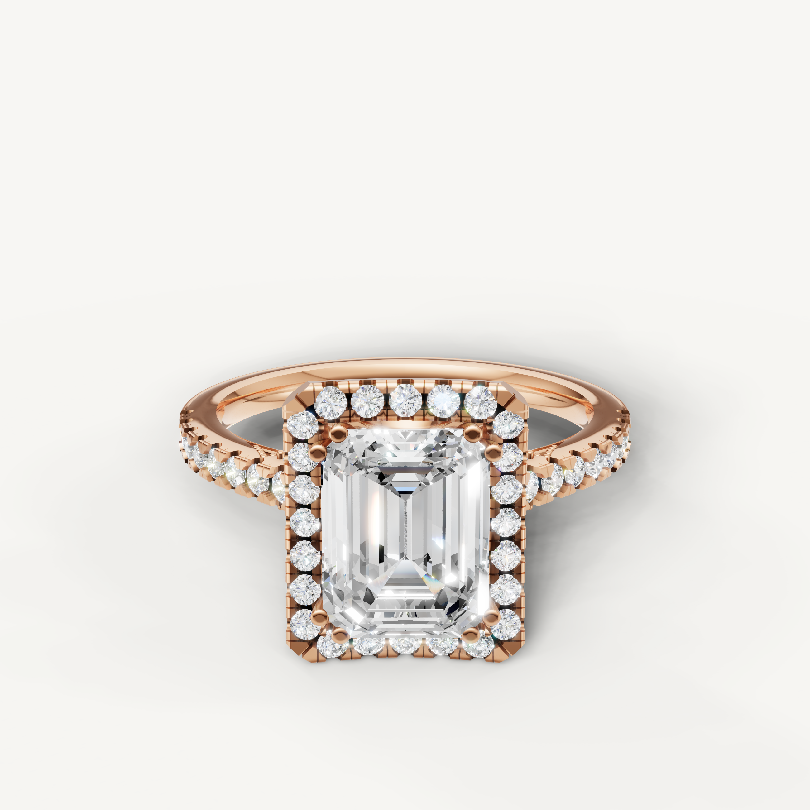 Emerald cut lab grown diamond halo engagement ring in 14K rose gold with pavé diamond band by Raul Diamonds