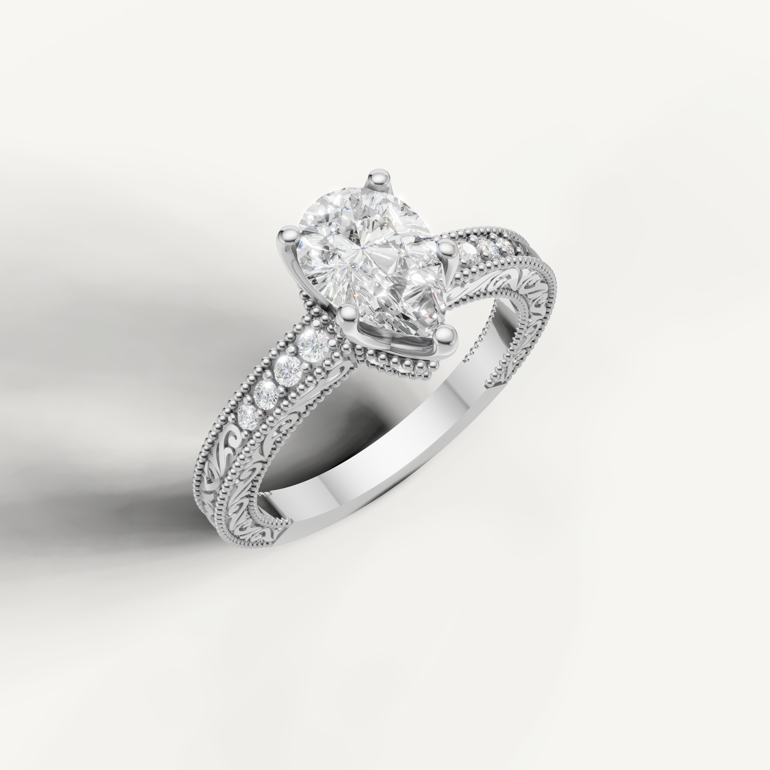 White gold pear cut lab grown diamond ring featuring antique-style scrollwork and delicate craftsmanship by Raul Diamonds.