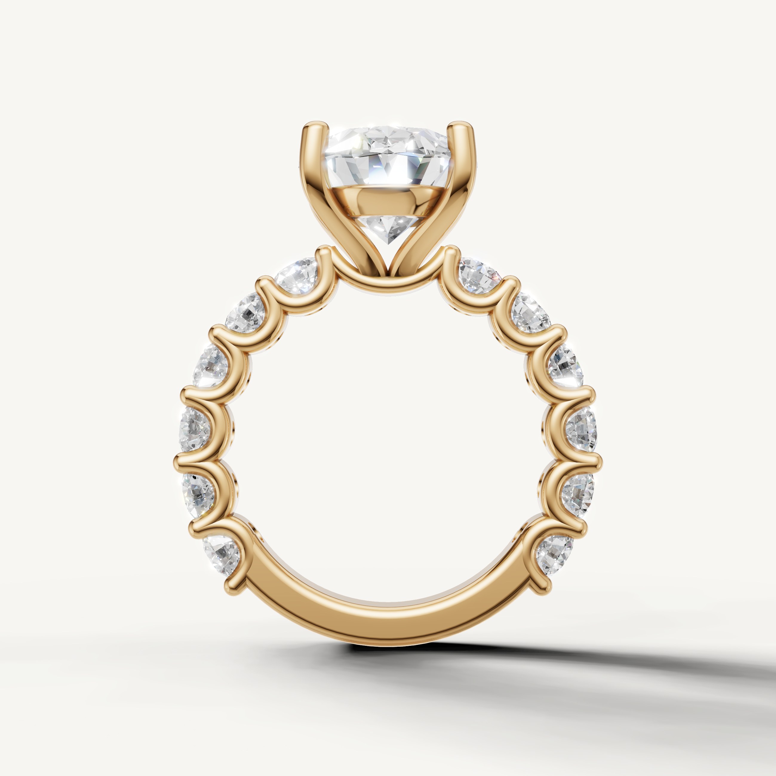 Elegant oval engagement ring with open gallery shared prong band yellow gold