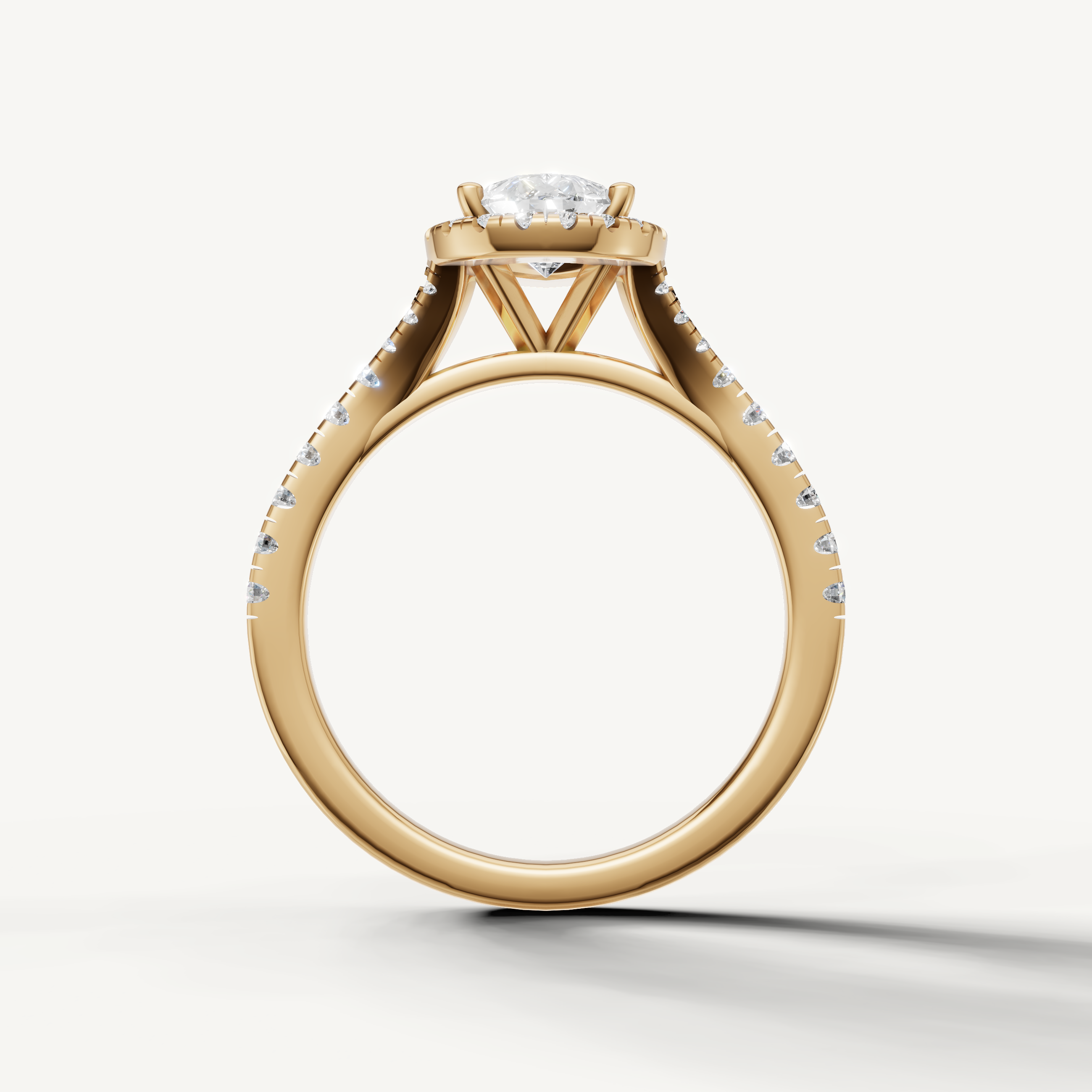 Elegant pear cut halo diamond ring with pavé band yellow gold