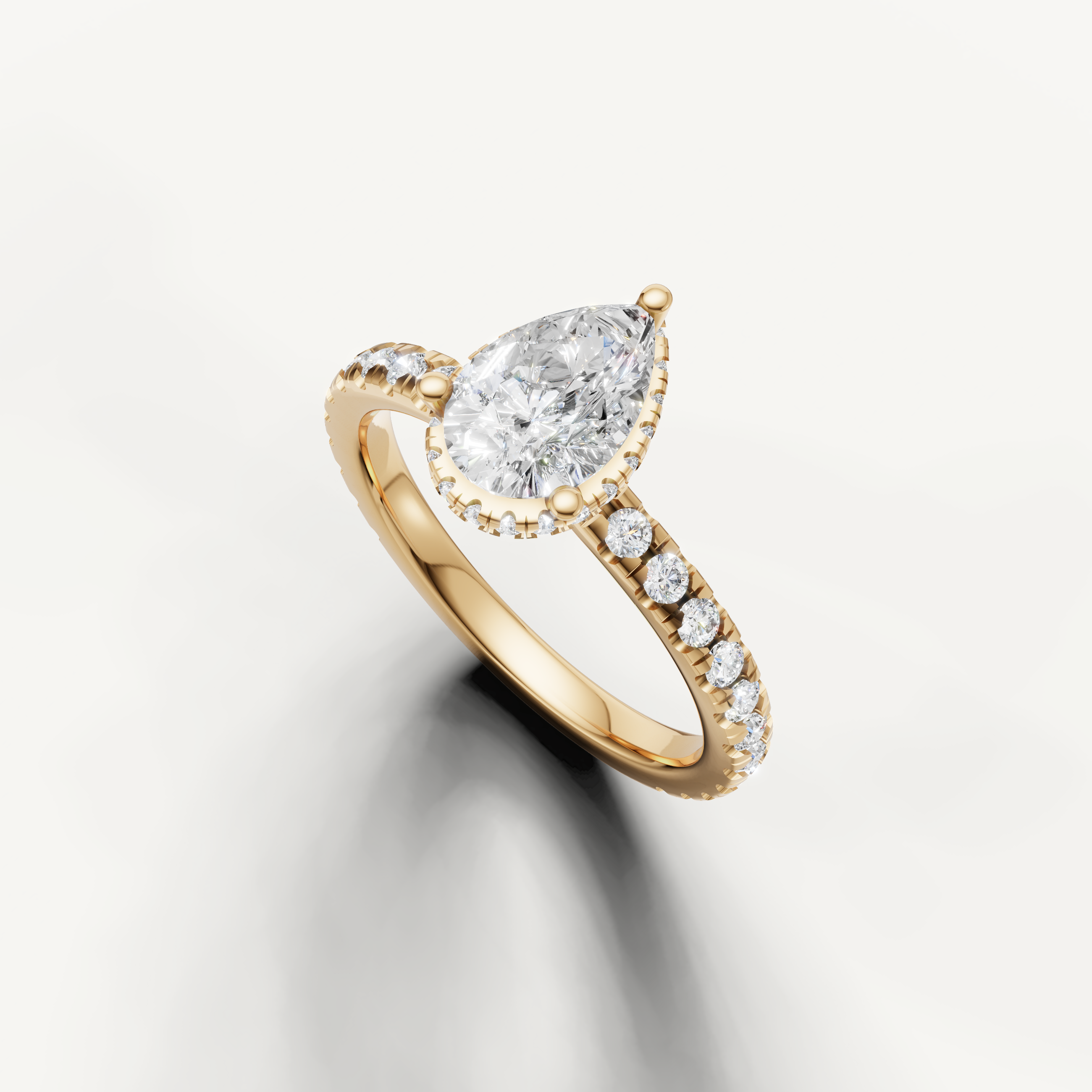 timeless pear cut lab grown diamond ring in 14k yellow gold featuring hidden halo brilliance and slim pavé band