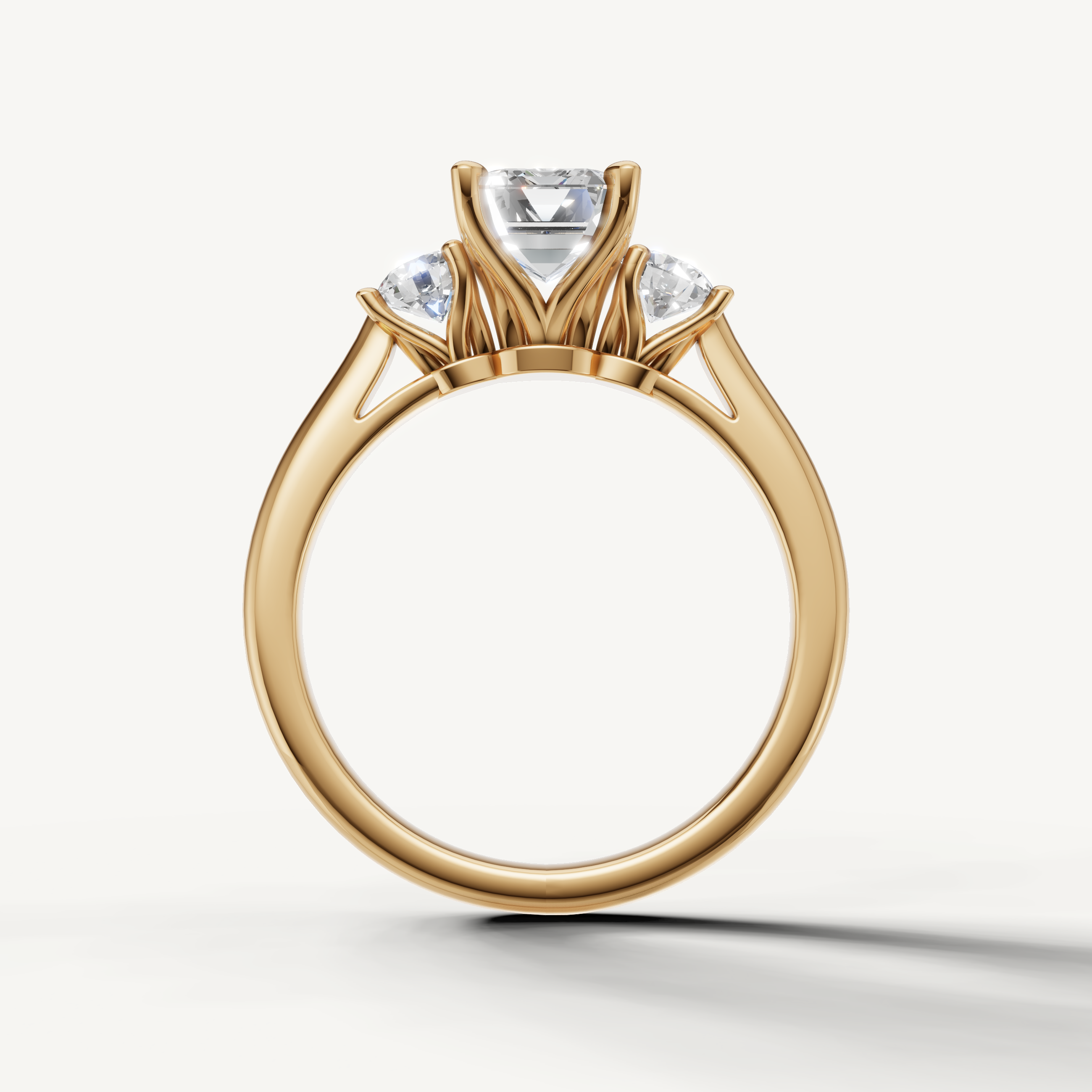 Elegant emerald cut diamond ring with round side stones in yellow gold