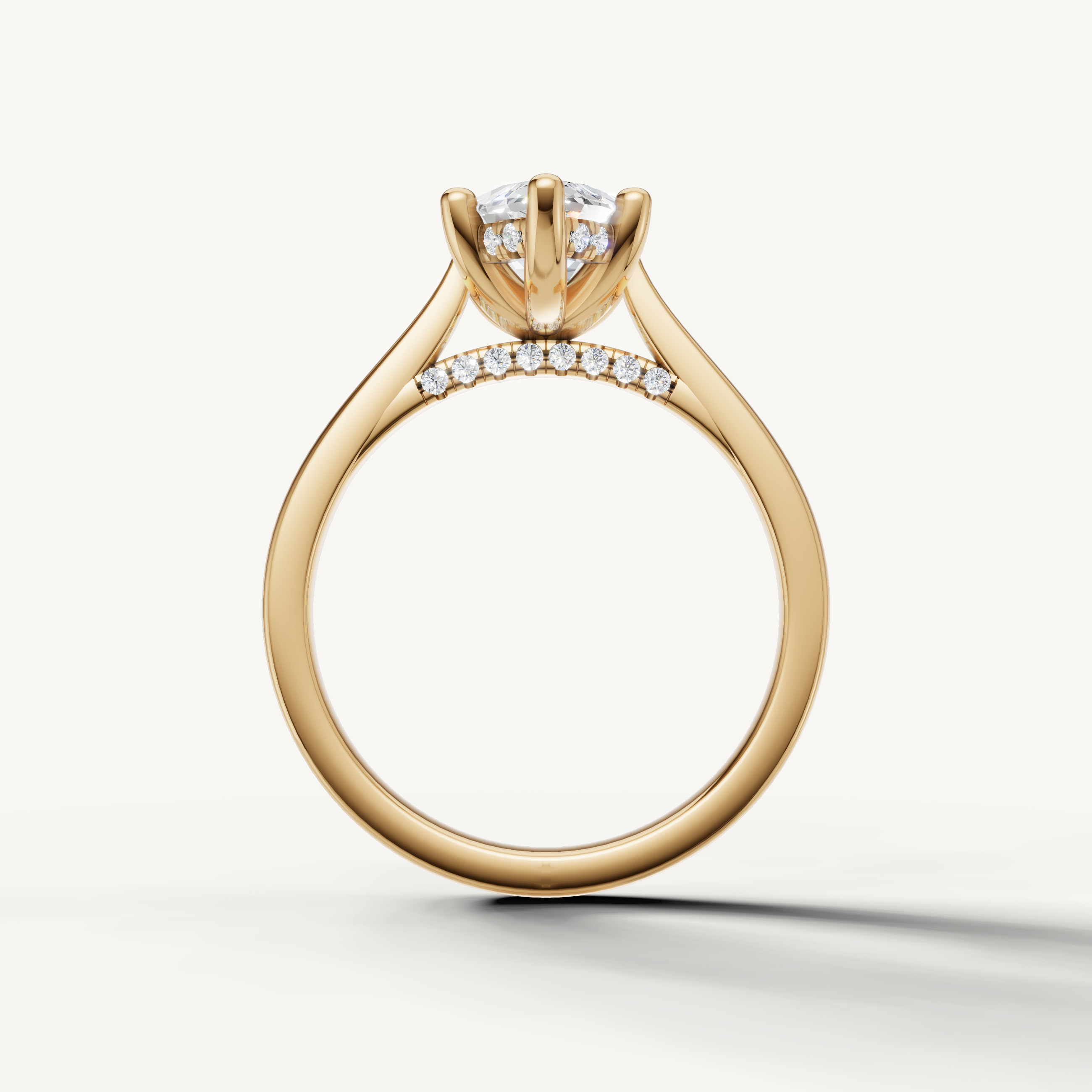 close up of marquise lab grown diamond engagement ring with sleek tapered yellow gold band