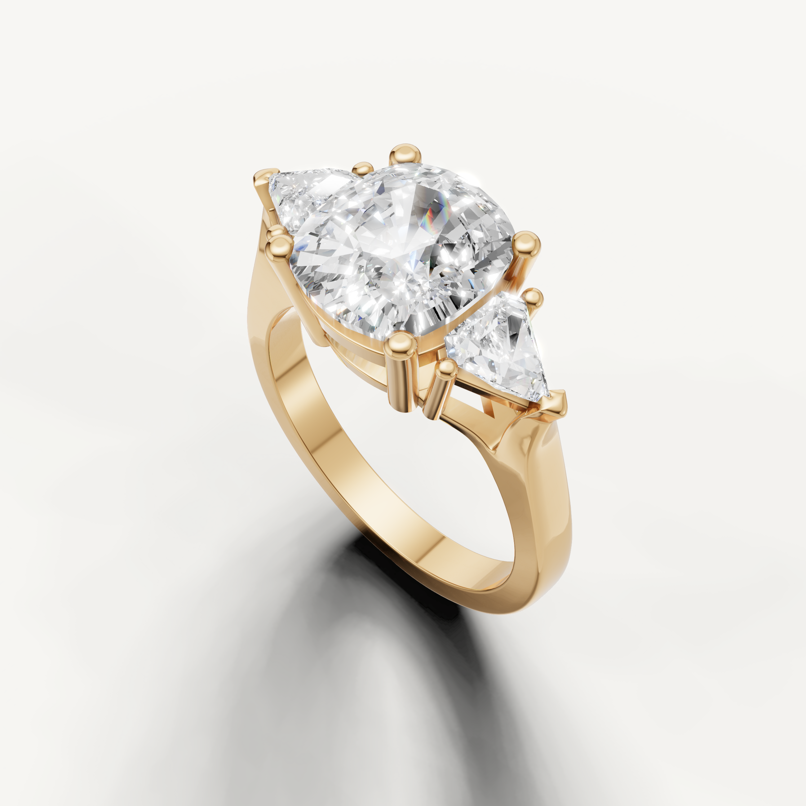 Round diamond engagement ring with tapered pear diamonds from Raul Diamonds