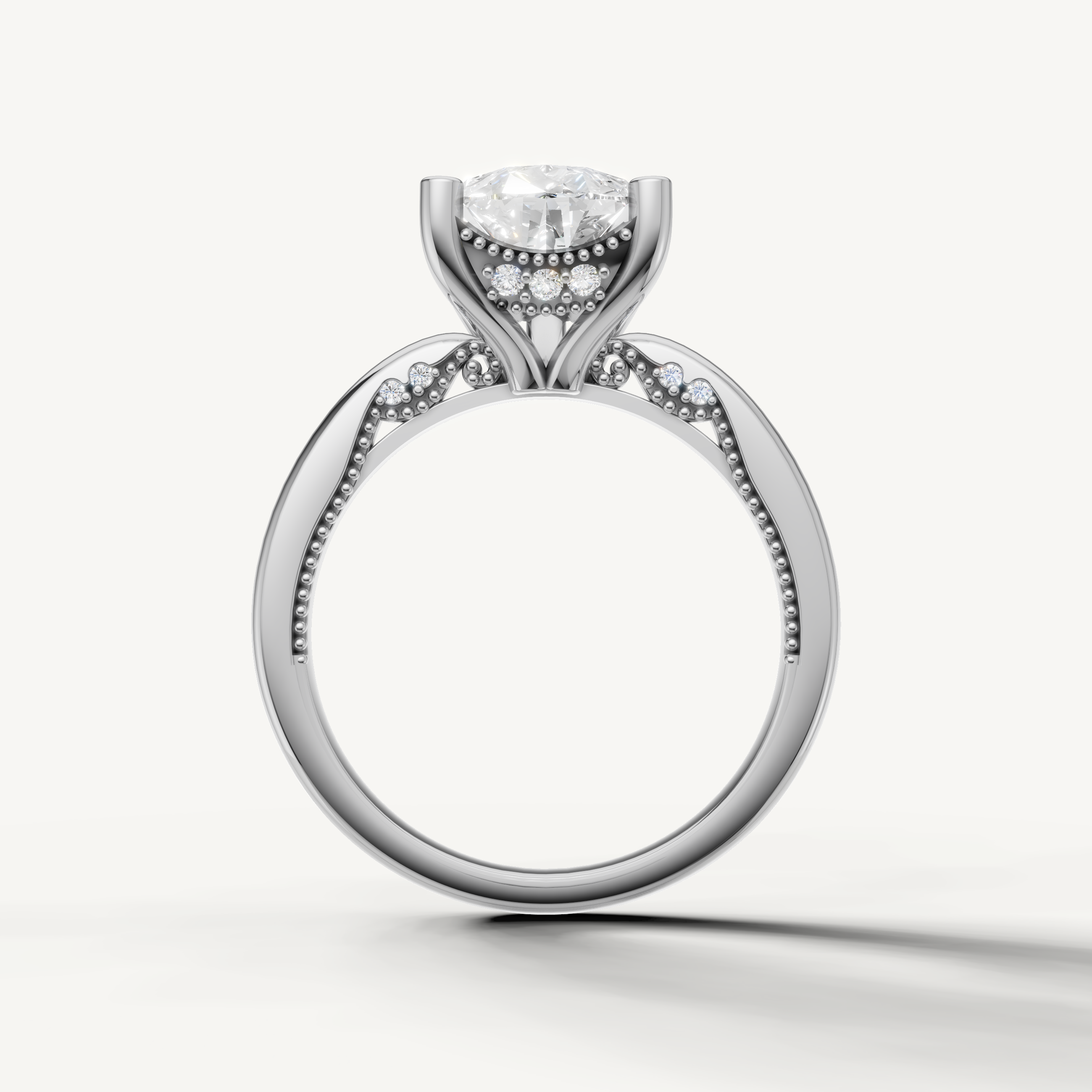 A luxury white gold engagement ring that maximizes the brilliance and fire of a central pear-cut diamond against a cool, bright metal finish.