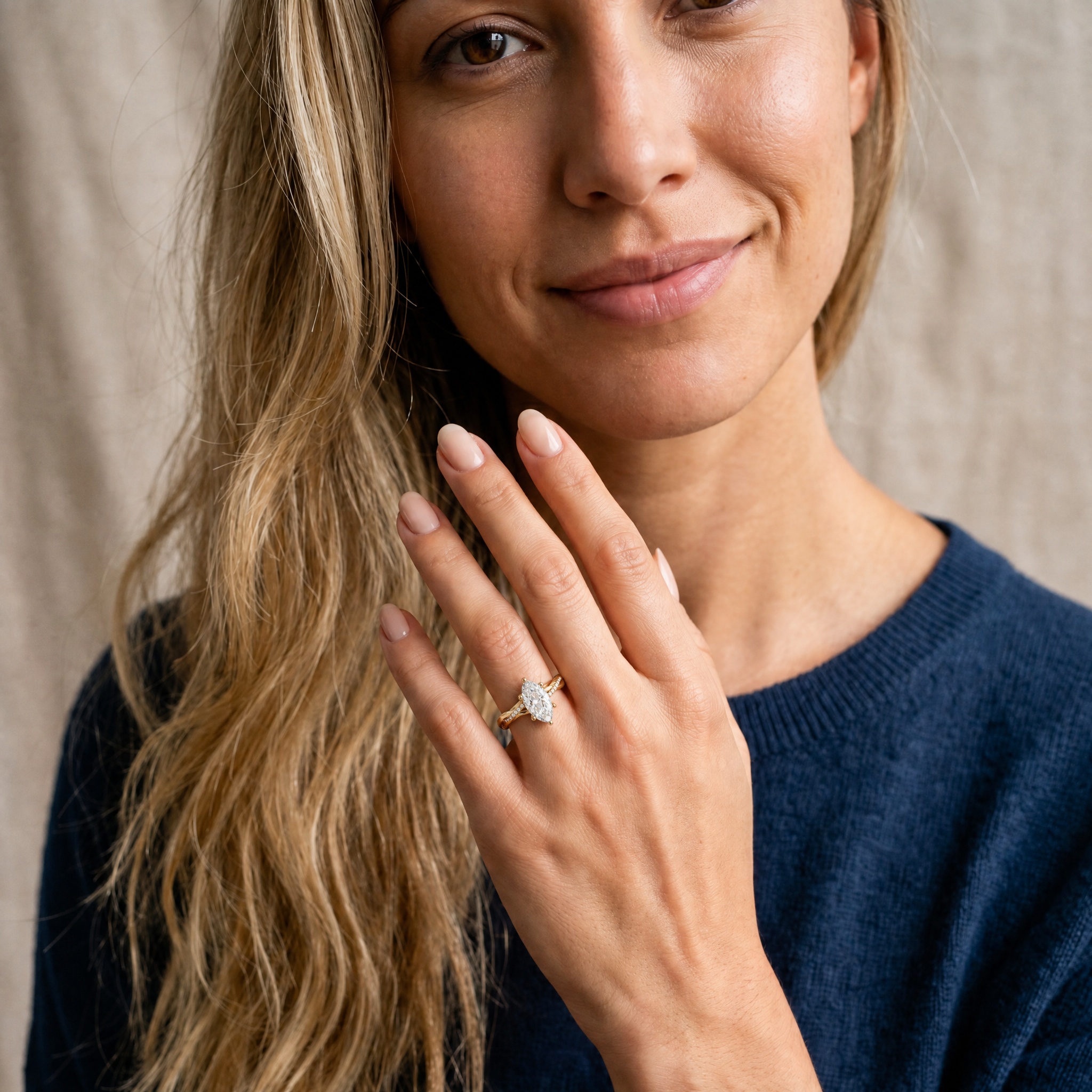 A stunning lifestyle shot showing a Raul Diamonds marquise cut diamond ring on a model's hand, highlighting the finger-elongating effect of the marquise shape and the sparkle of the twisted pavé band