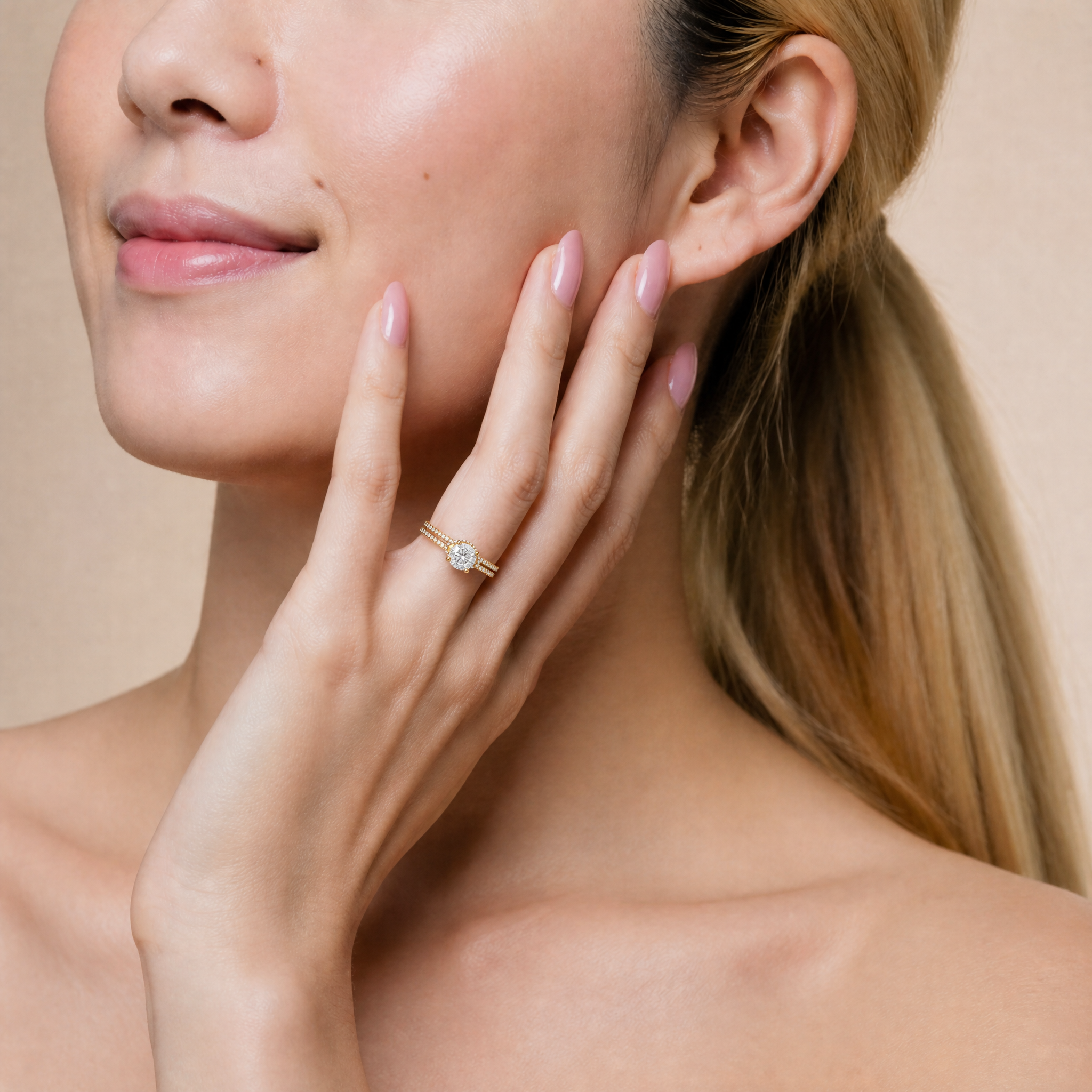 Model wearing a Raul Diamonds round brilliant solitaire engagement ring with split pave band.