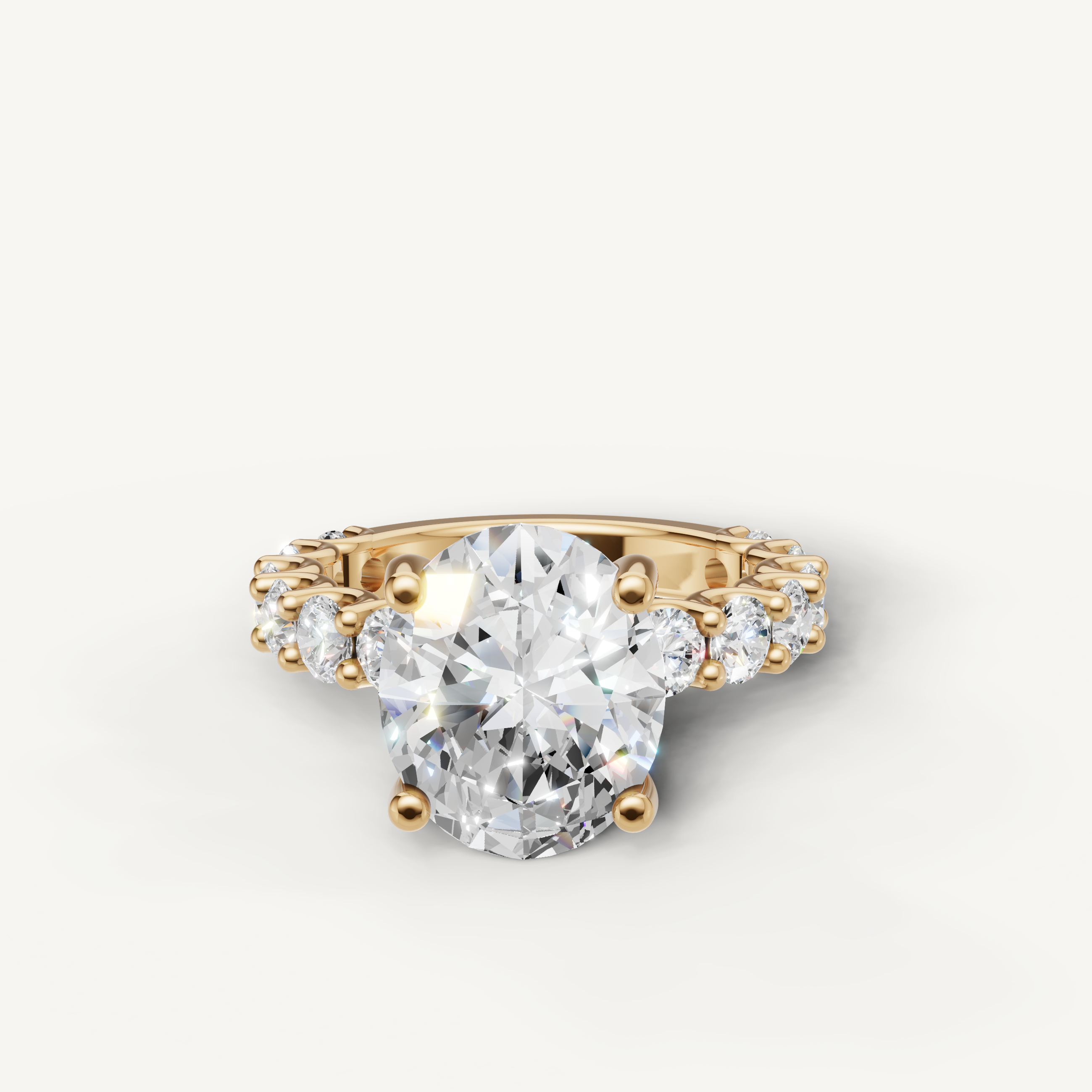 Oval cut lab grown diamond engagement ring with shared prong side stones in 14K yellow gold