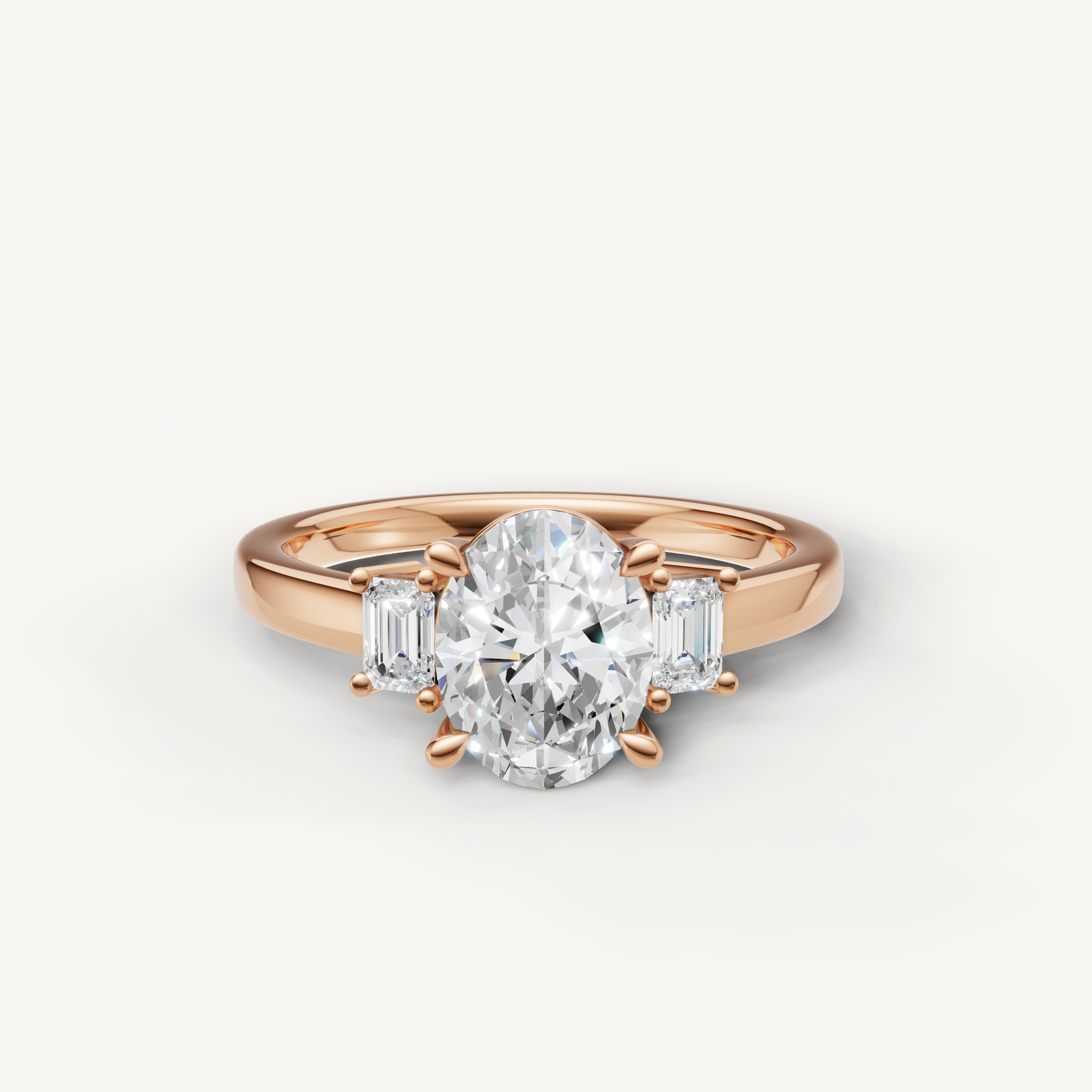 Oval cut lab grown diamond three stone engagement ring in 14K rose gold with emerald cut side stones