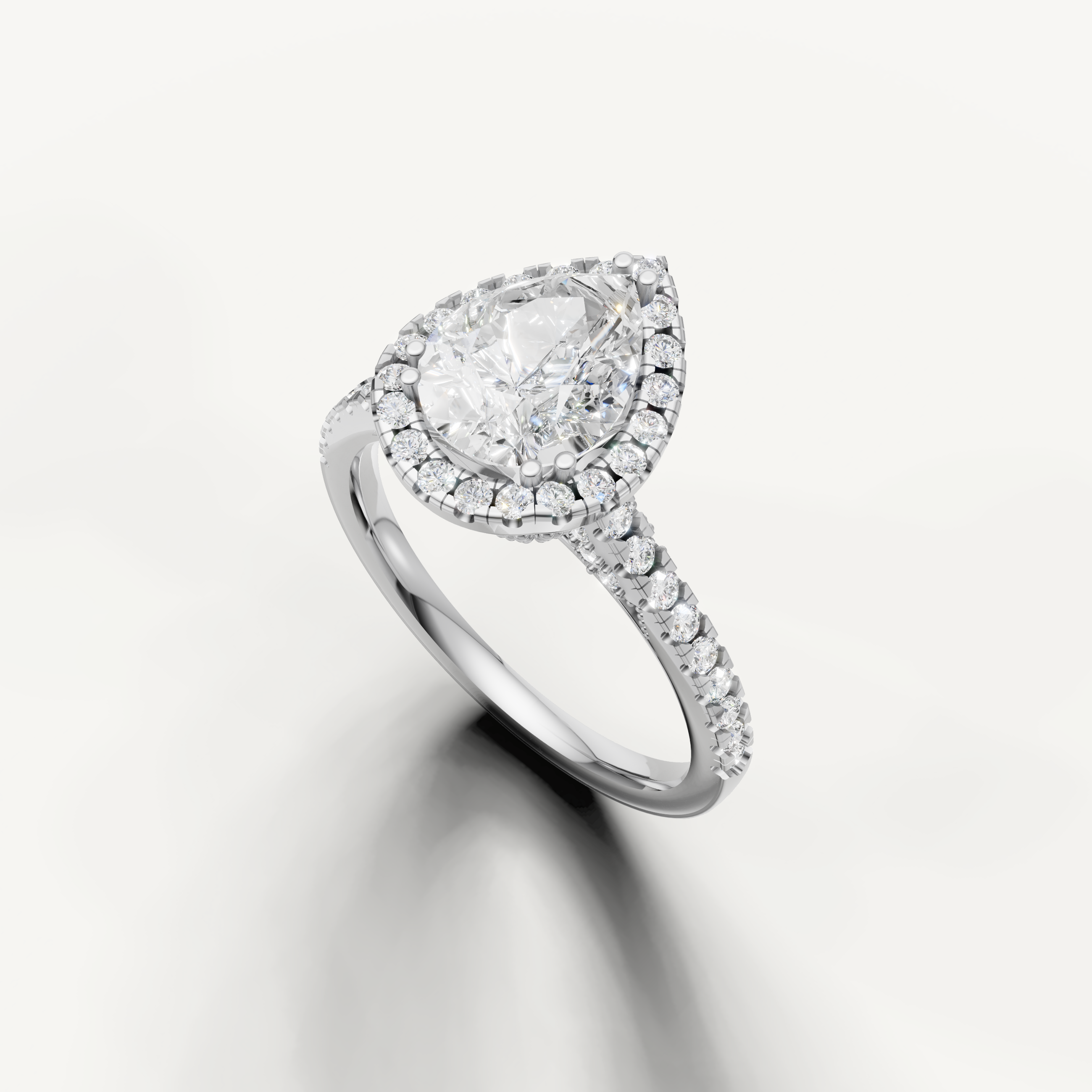 White gold pear cut lab grown diamond ring featuring a timeless halo setting and sparkling pavé band