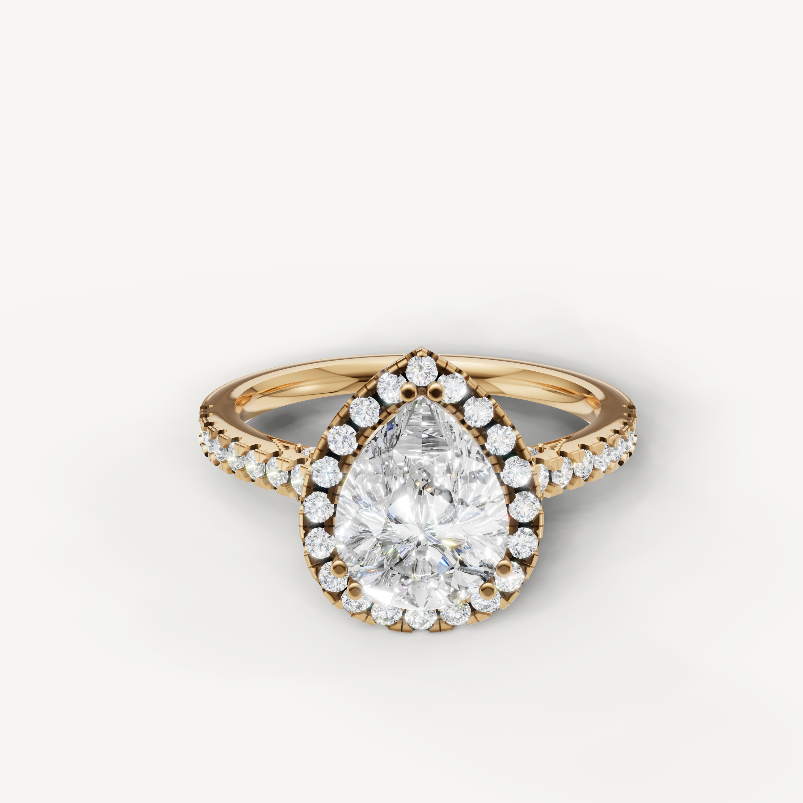 Pear cut lab grown diamond halo engagement ring in 14K yellow gold with pavé diamond band by Raul Diamonds