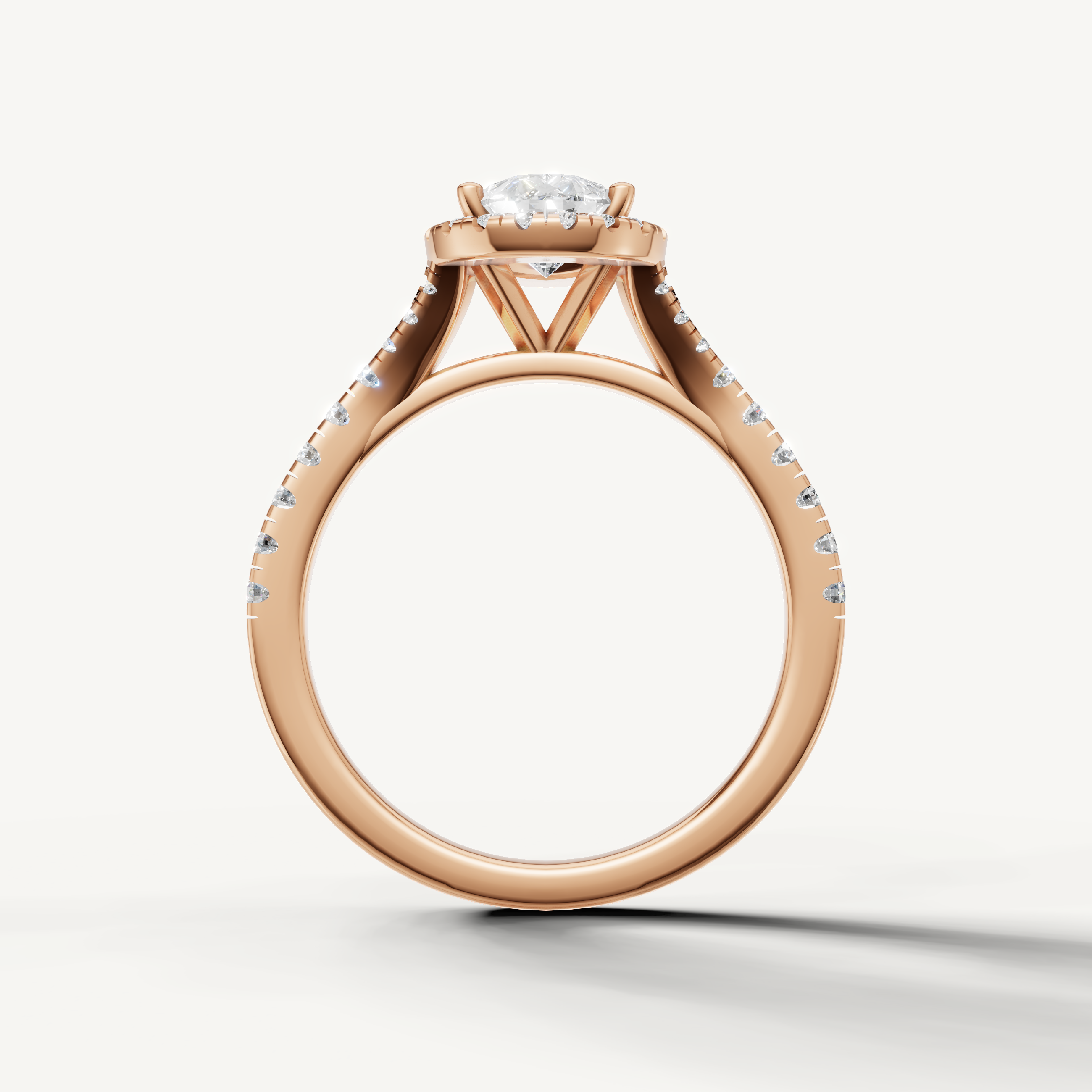 Pear cut engagement ring with halo and pavé band rose gold