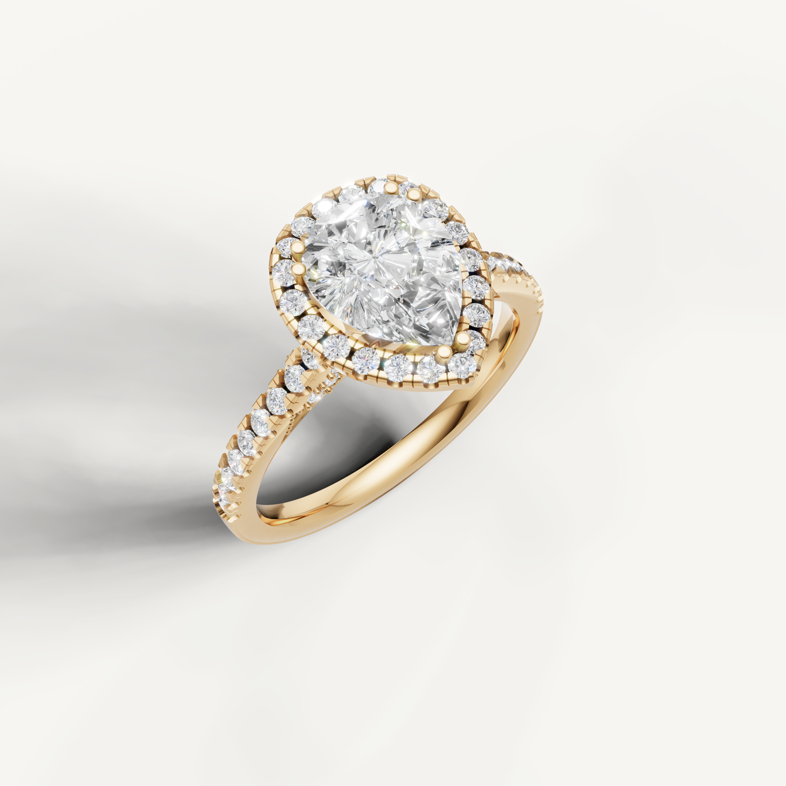 14K yellow gold pear lab diamond engagement ring with sparkling halo and pavé shank from Raul Diamonds