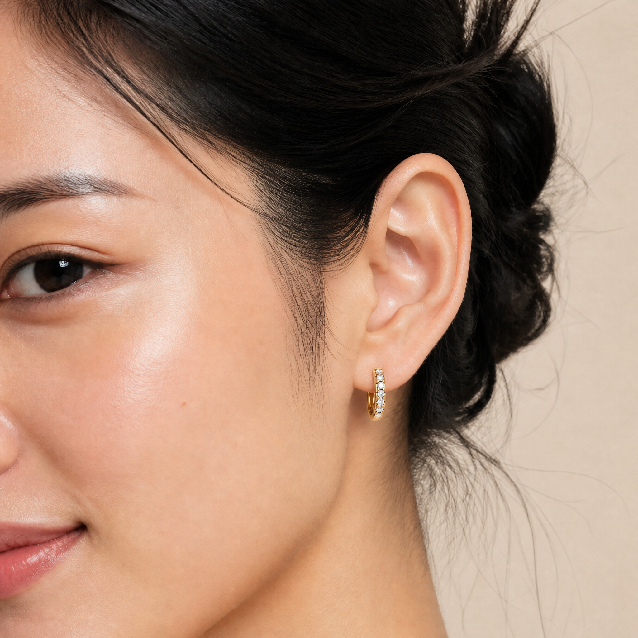 Elegant model wearing Raul Diamonds diamond hoop earrings with luxurious pave sparkle styling