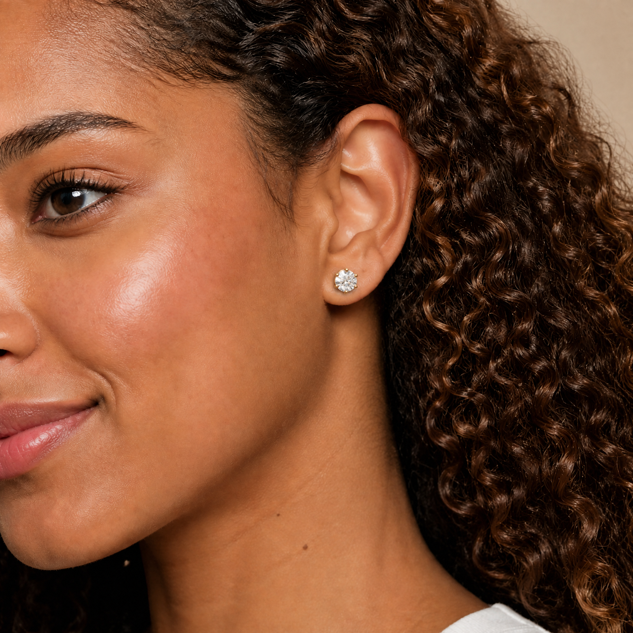Elegant model wearing Raul Diamonds round diamond stud earrings with timeless solitaire styling