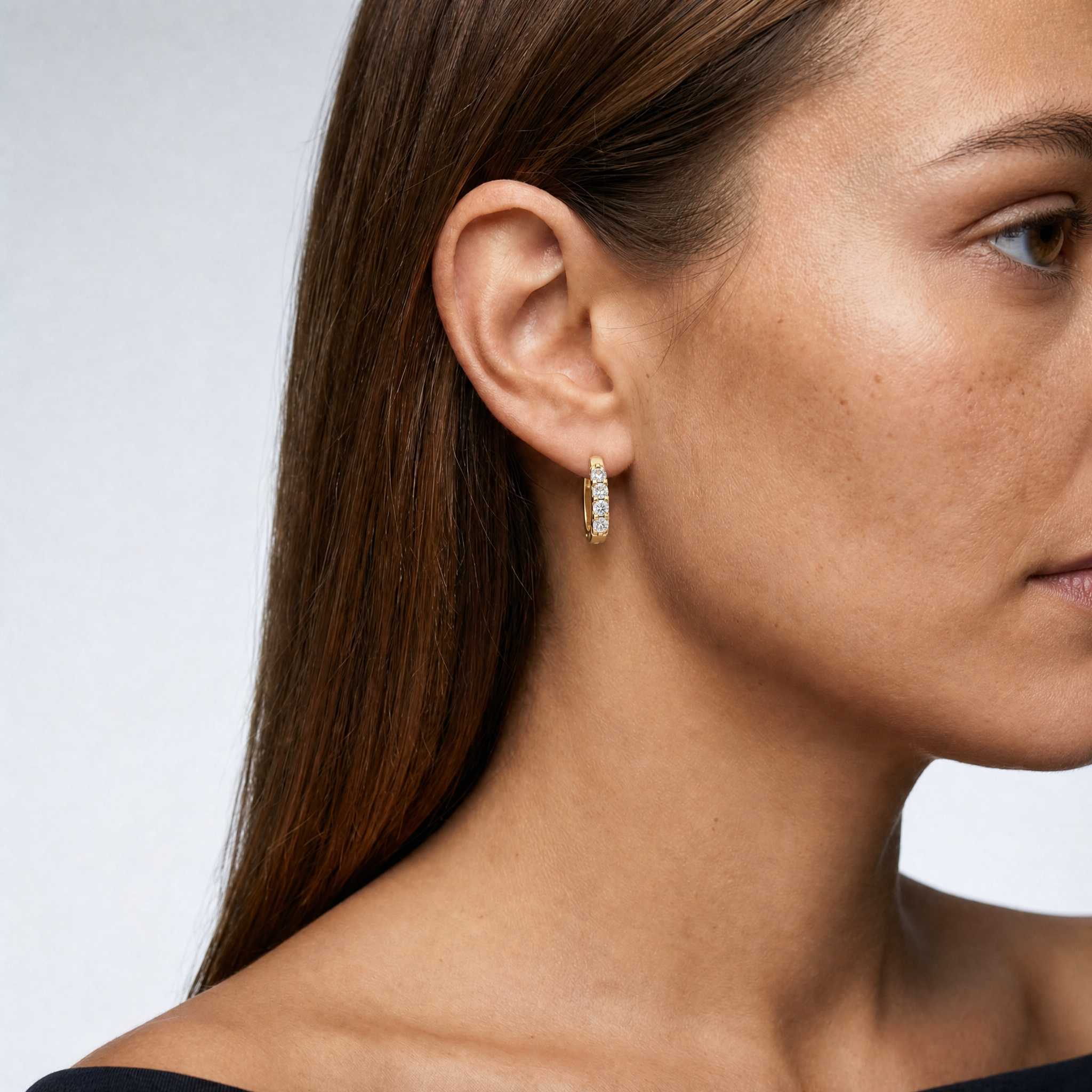 Elegant model wearing Raul Diamonds round diamond hoop earrings with brilliant sparkle