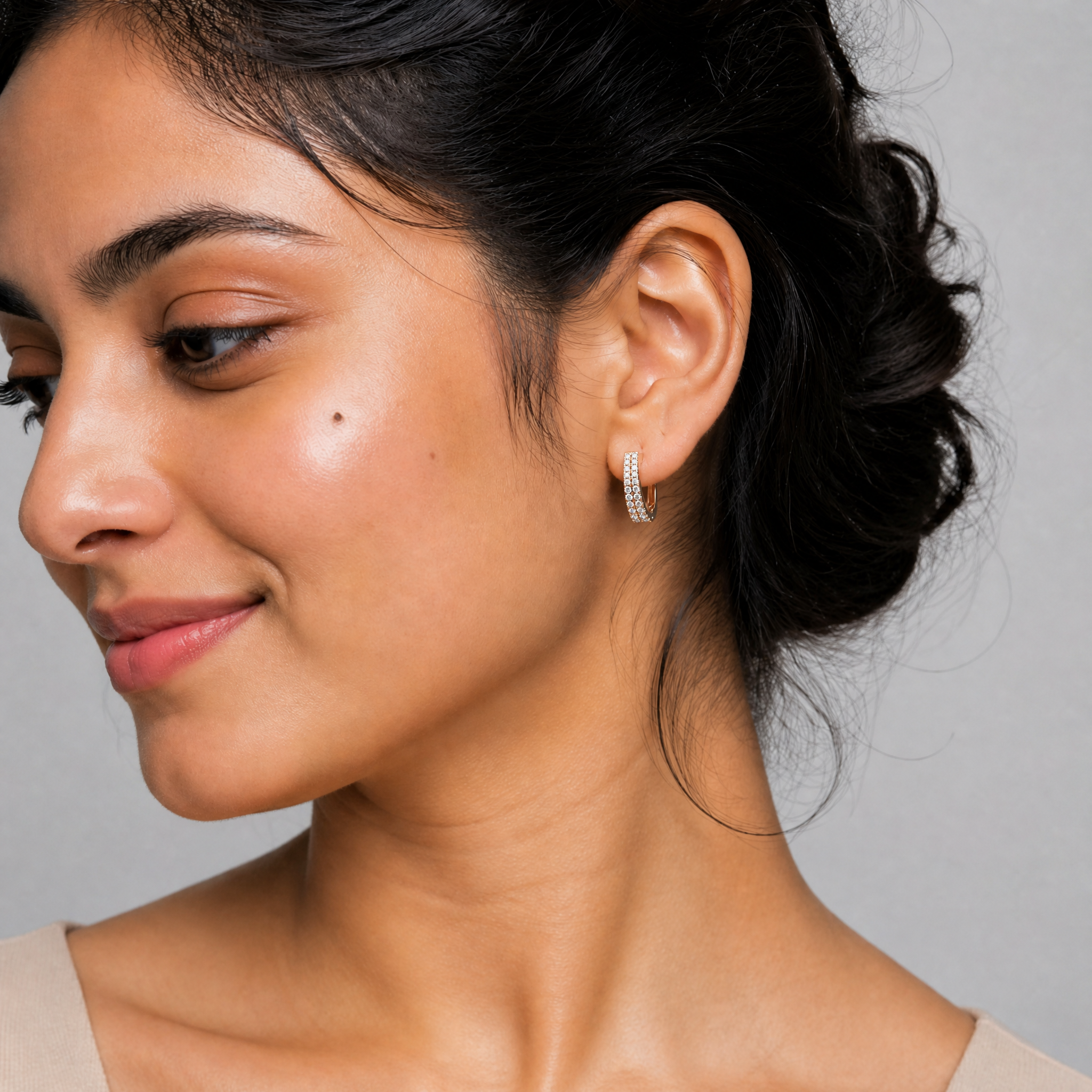 Female model wearing Raul Diamonds double row diamond hoop earrings in rose gold