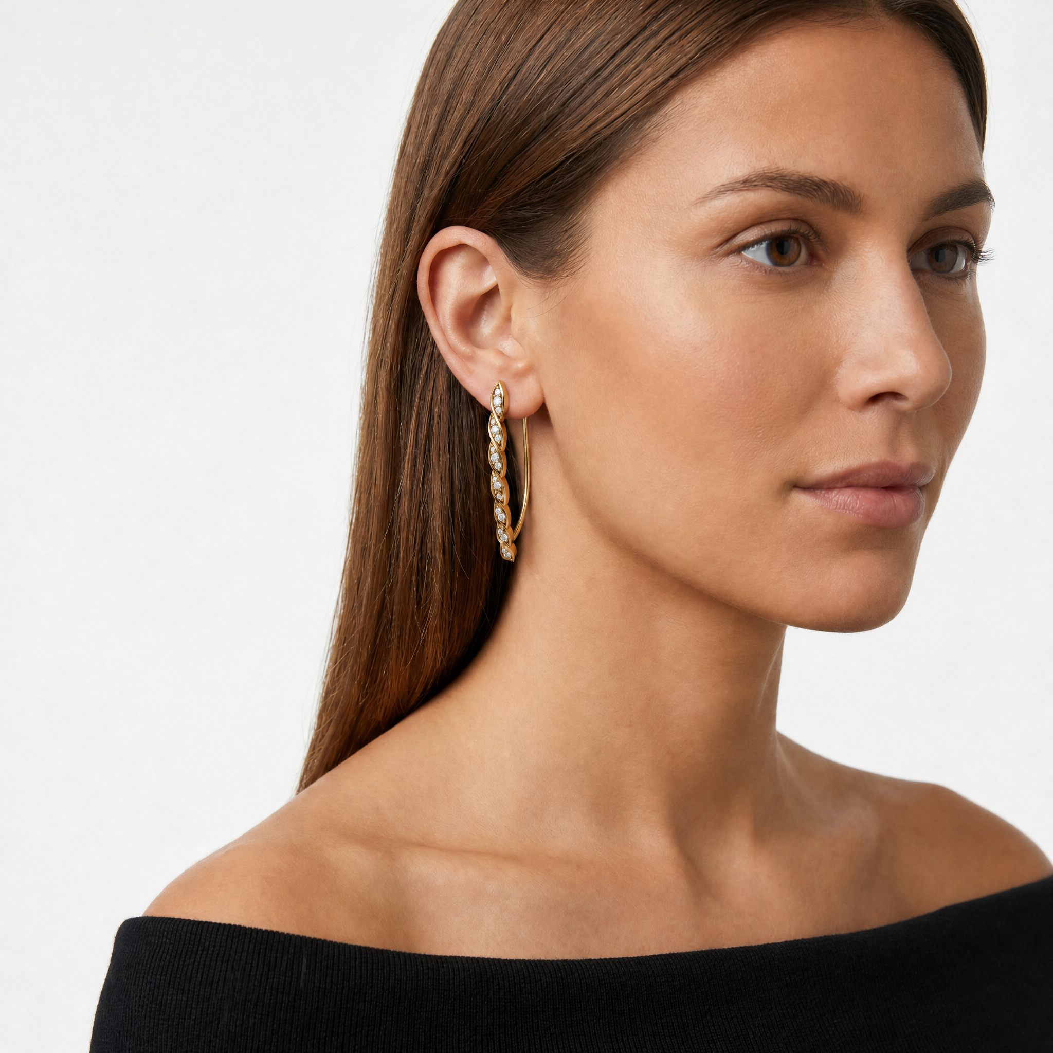 Model wearing Raul Diamonds luxury diamond leaf earrings in gold finish