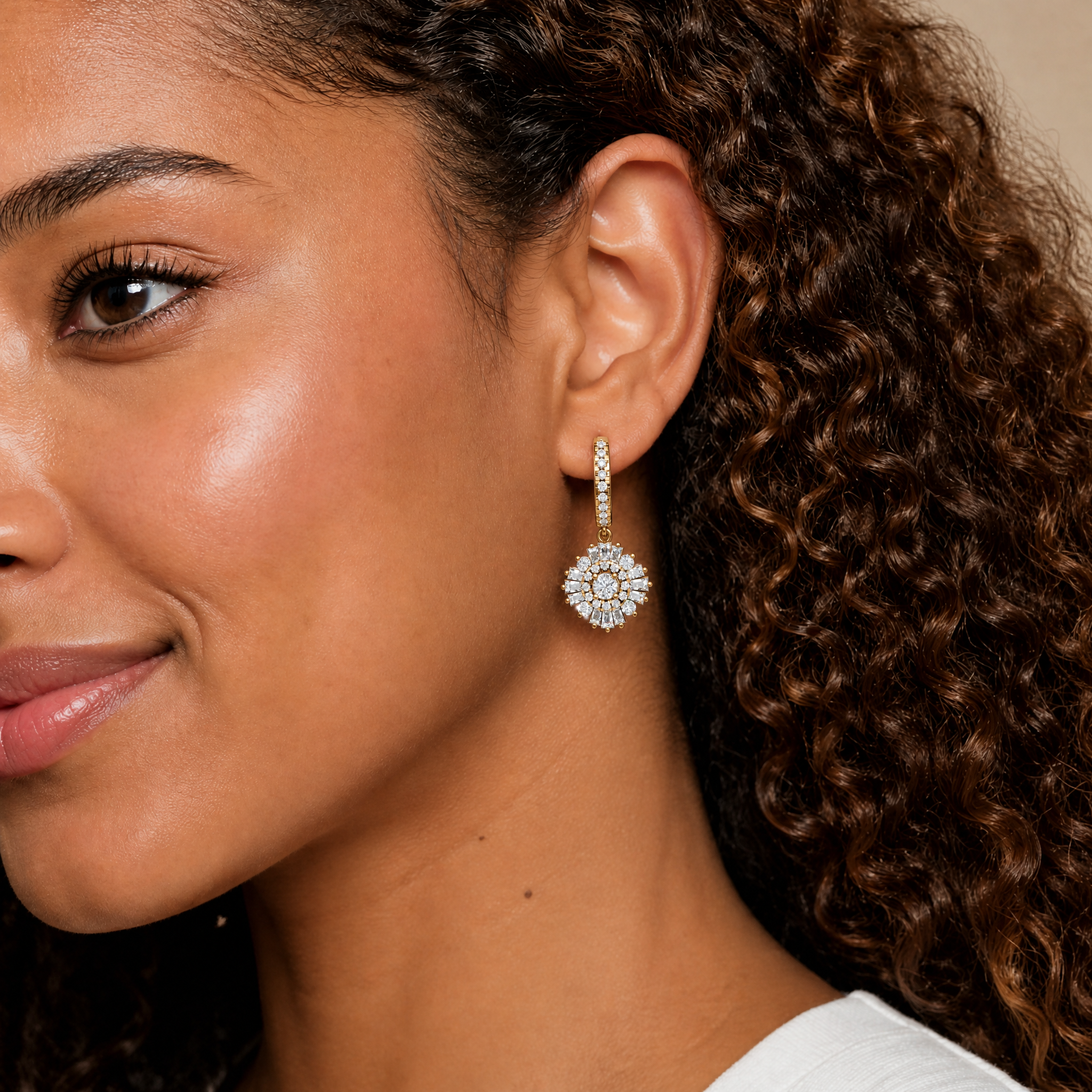 Model wearing Raul Diamonds luxury diamond halo drop earrings in gold finish