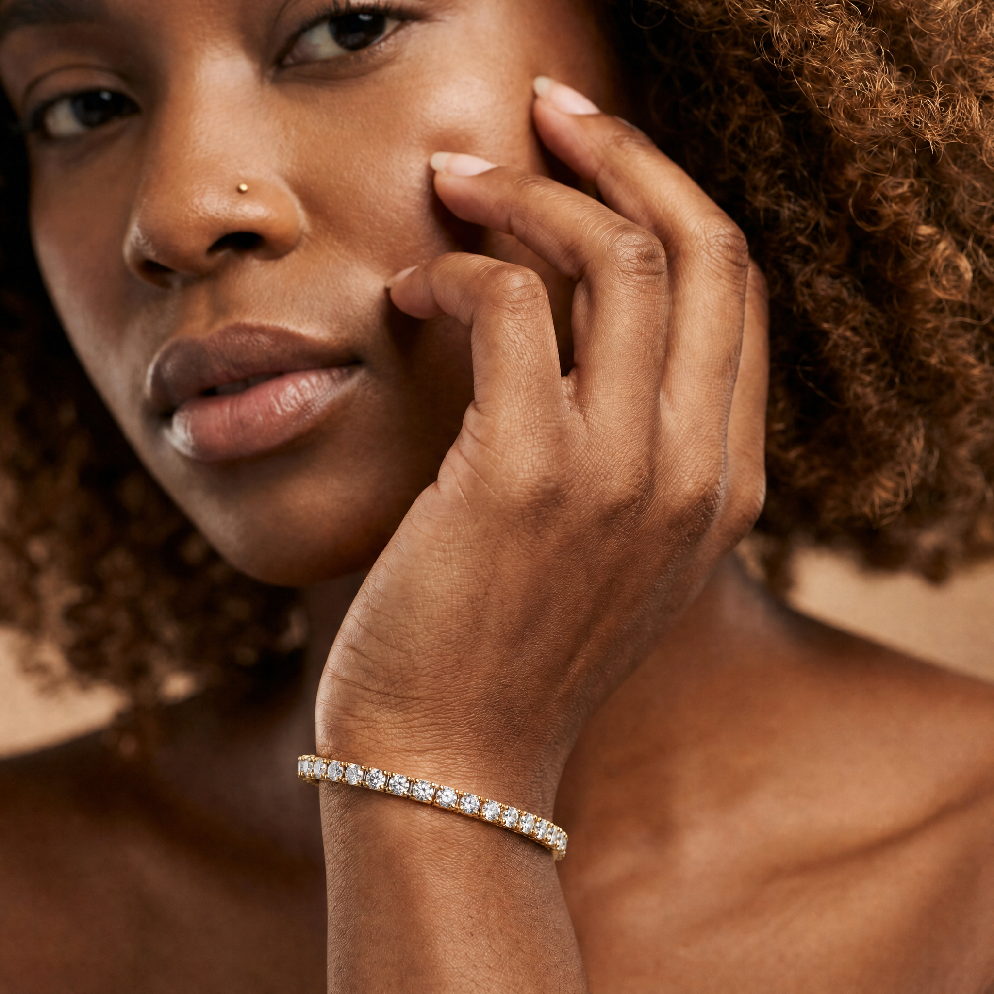 Model wearing Raul Diamonds round diamond tennis bracelet in luxurious yellow gold finish