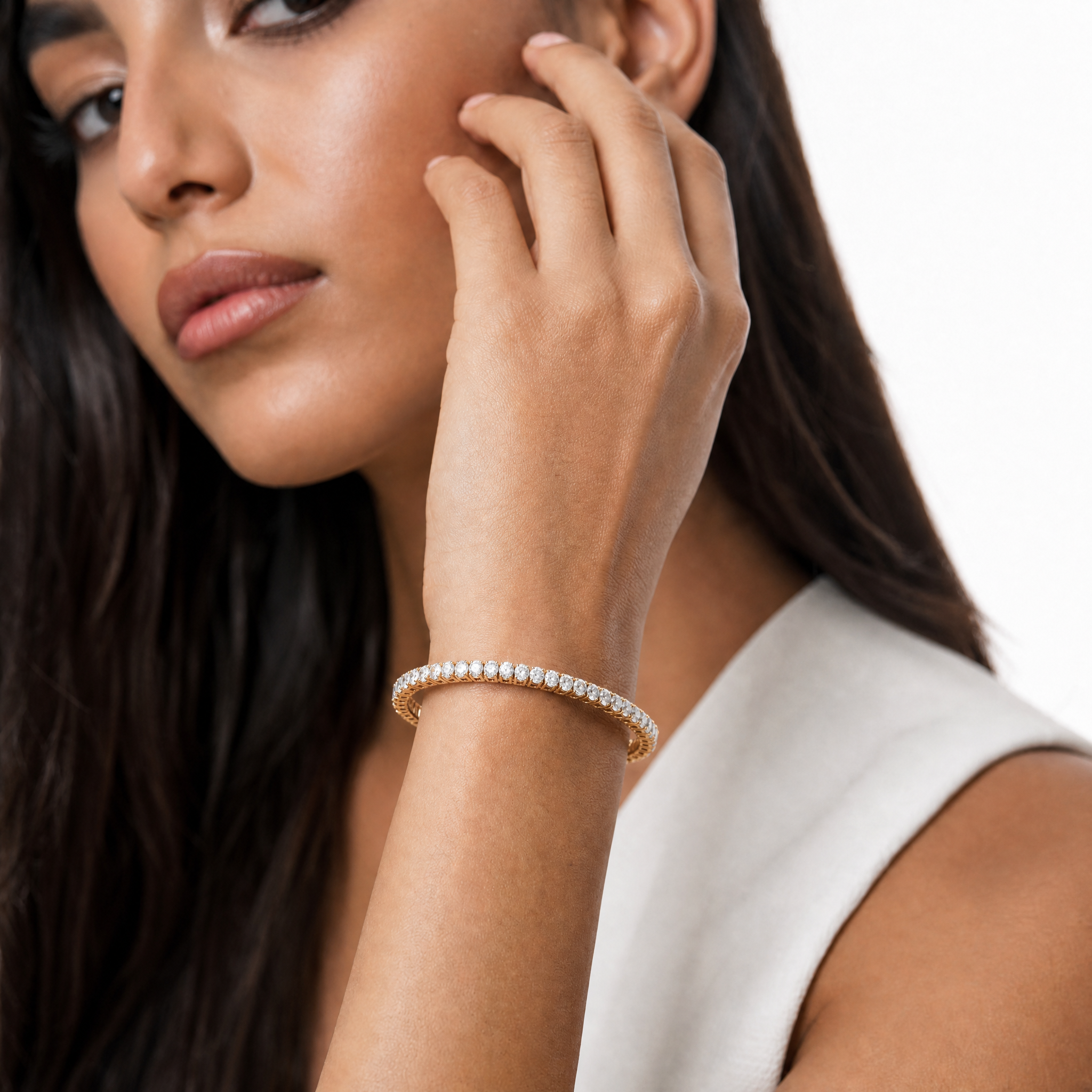 Model wearing Raul Diamonds oval diamond tennis bracelet in yellow gold luxury jewelry style