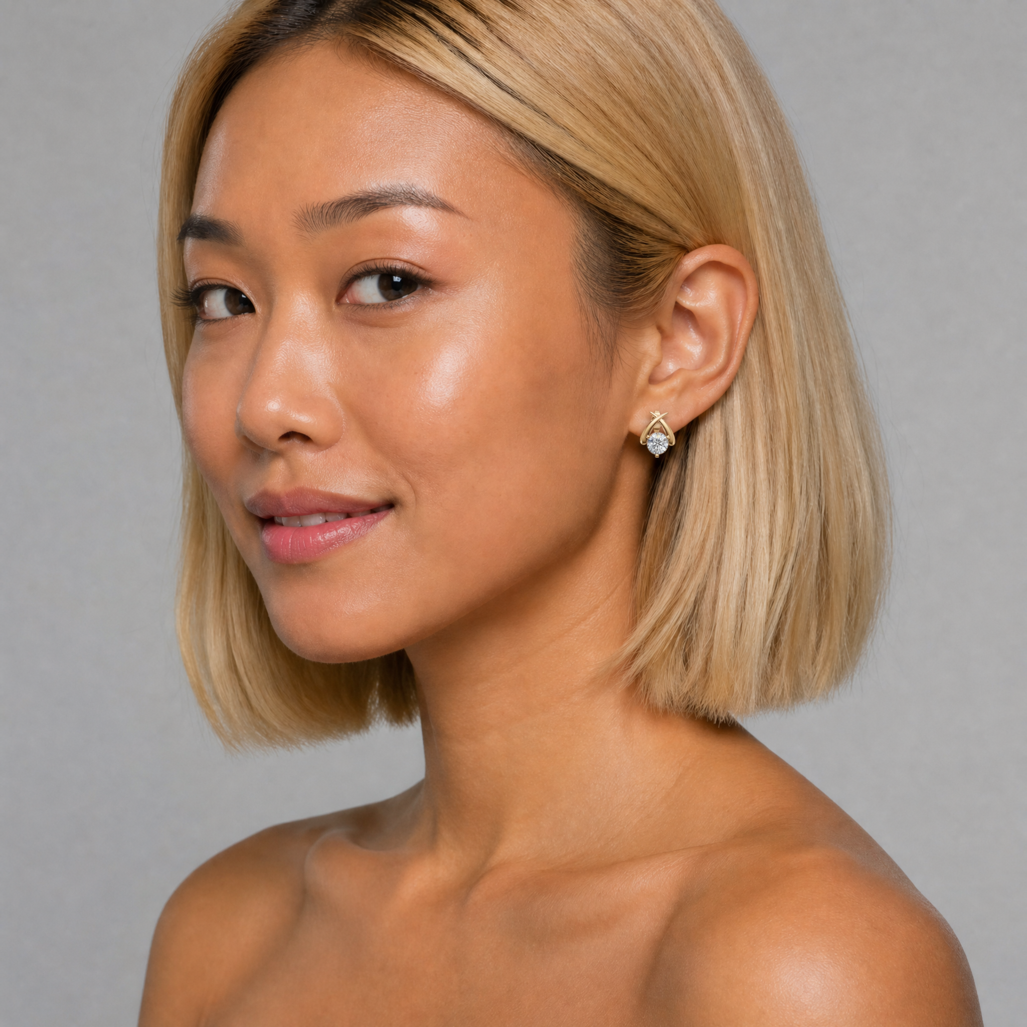 Elegant model wearing Raul Diamonds crossover diamond stud earrings with luxury sparkle