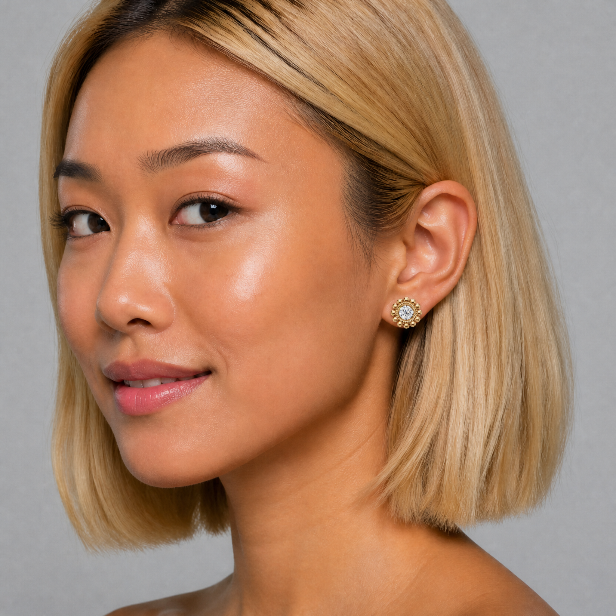 Elegant model wearing Raul Diamonds vintage halo diamond stud earrings with floral detailing