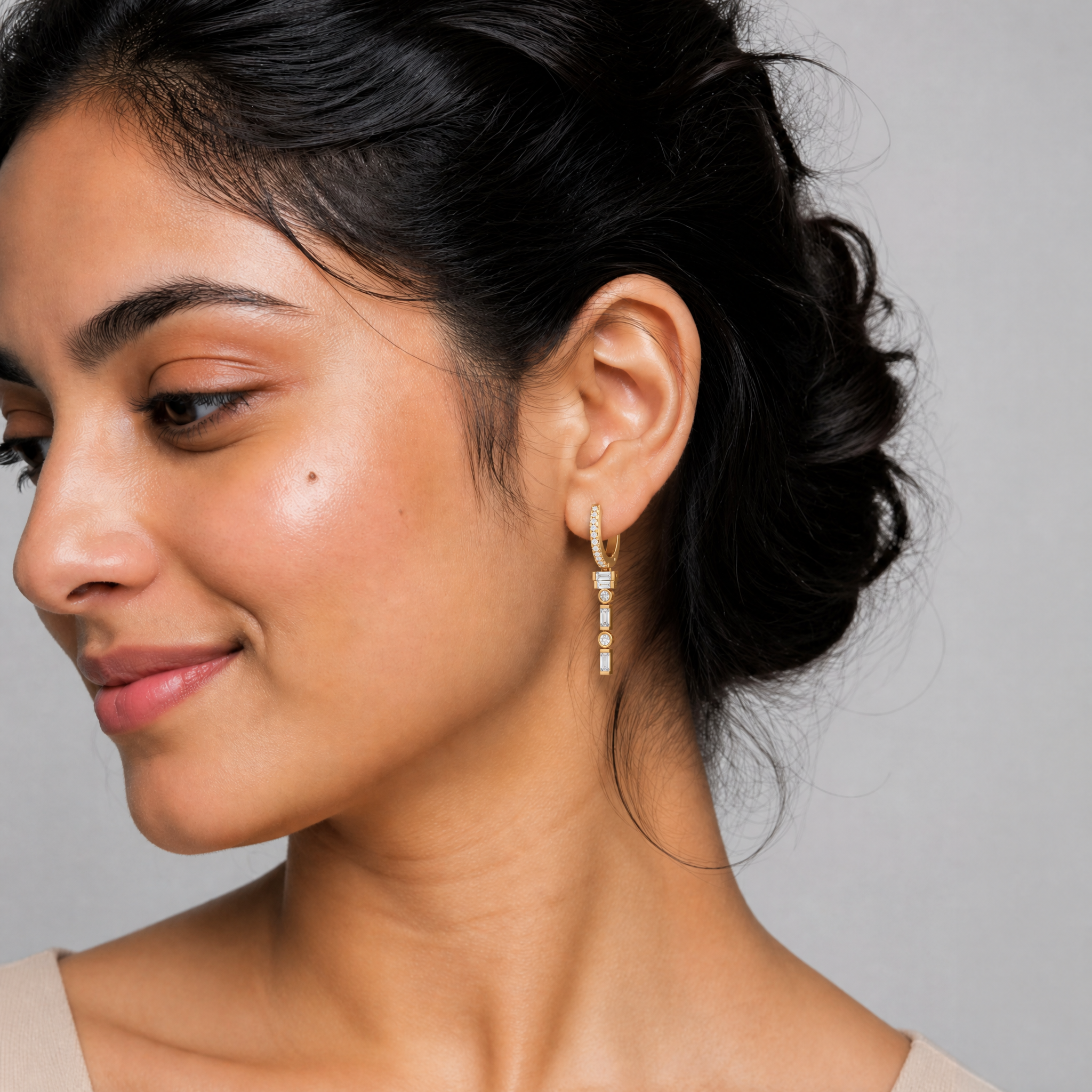 Female model wearing Raul Diamonds geometric baguette and round diamond hoop earrings