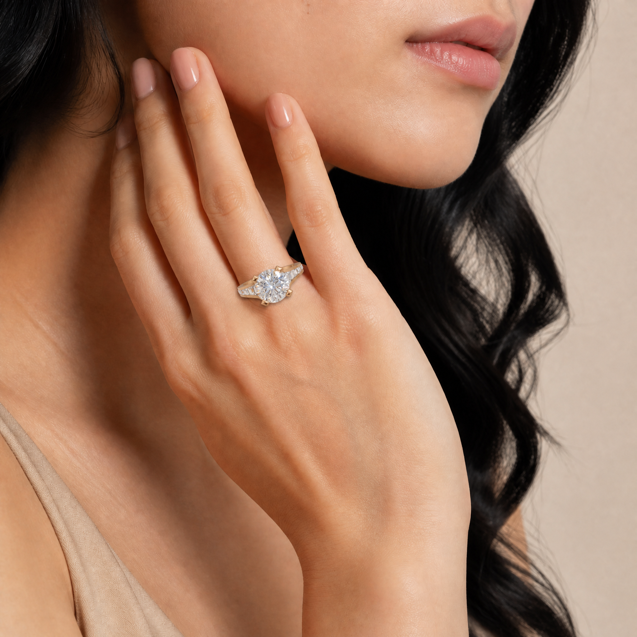 Model wearing Raul Diamonds round cut diamond engagement ring in yellow gold with pavé band