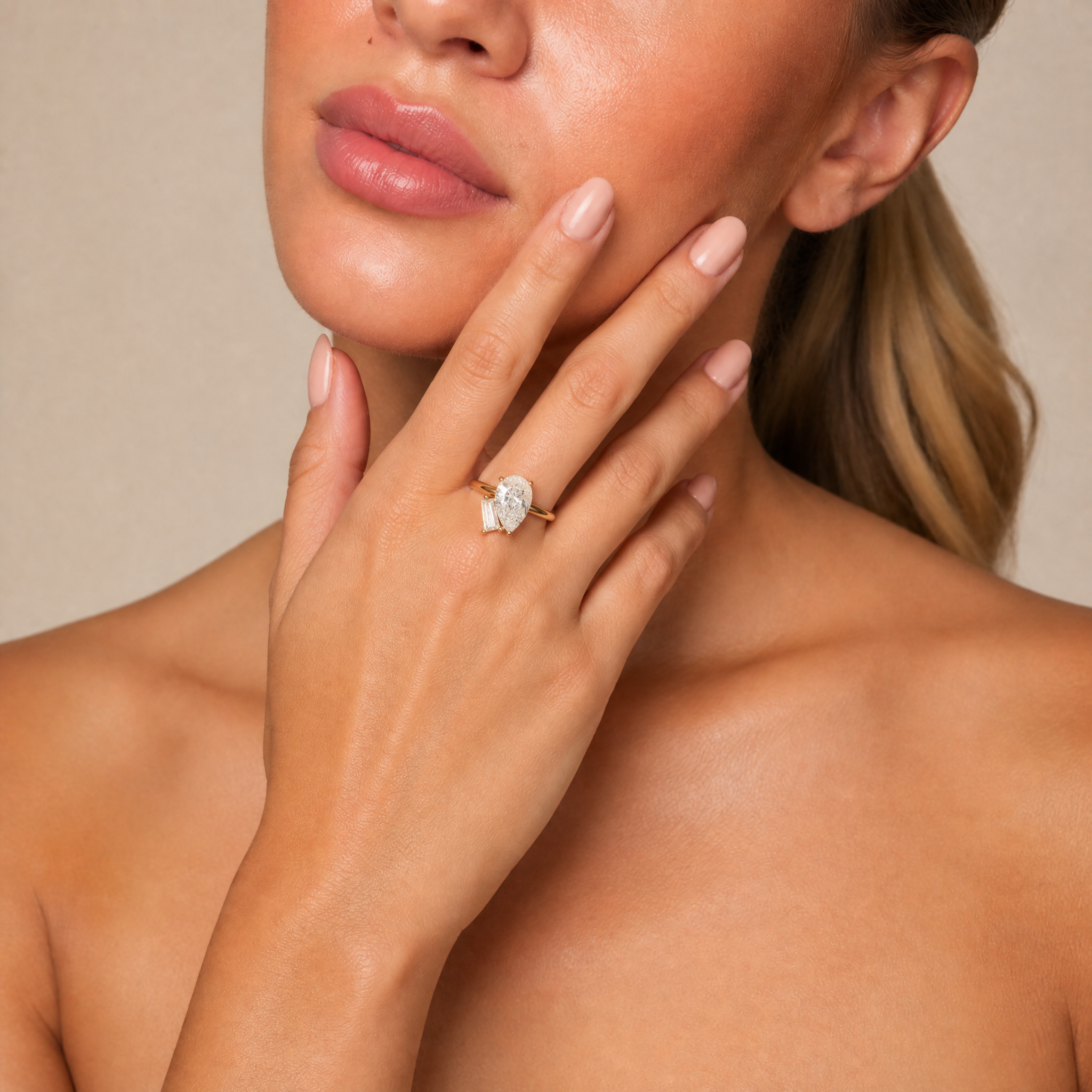 Model Isabella Grace wearing Raul Diamonds yellow gold toi et moi ring with pear and trapezoid cut diamonds
