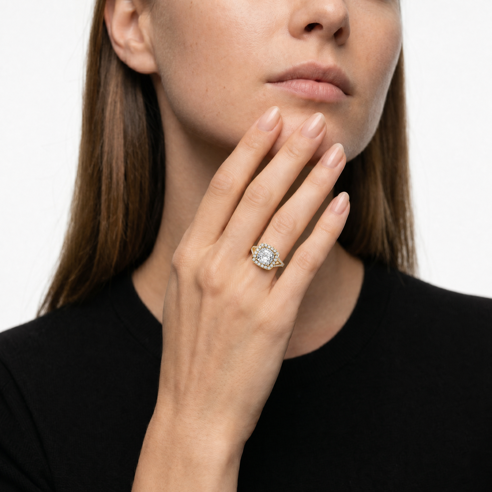 Model wearing Raul Diamonds cushion cut halo diamond engagement ring in yellow gold with split shank band