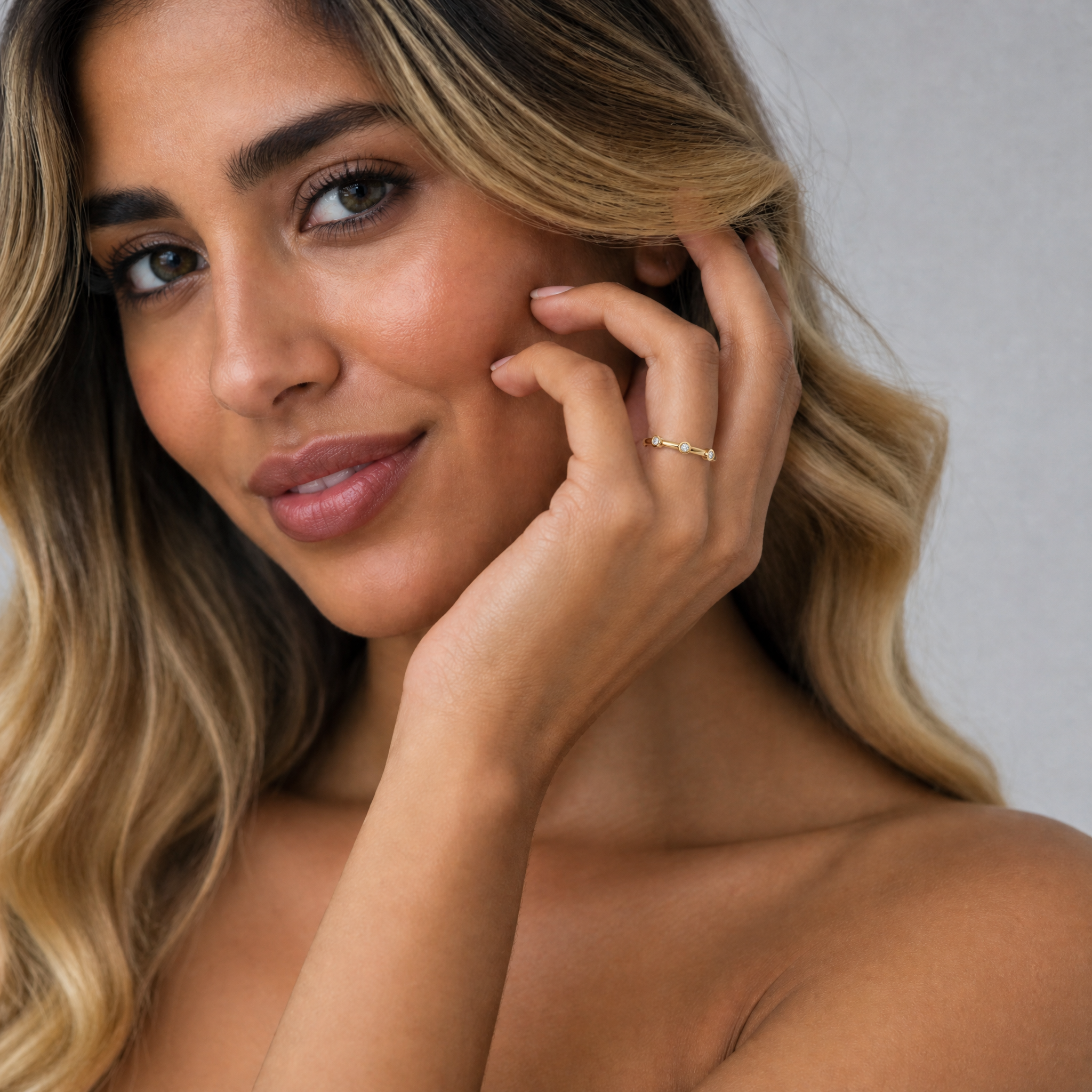 Model wearing Raul Diamonds bezel set diamond wedding band in yellow gold minimalist style