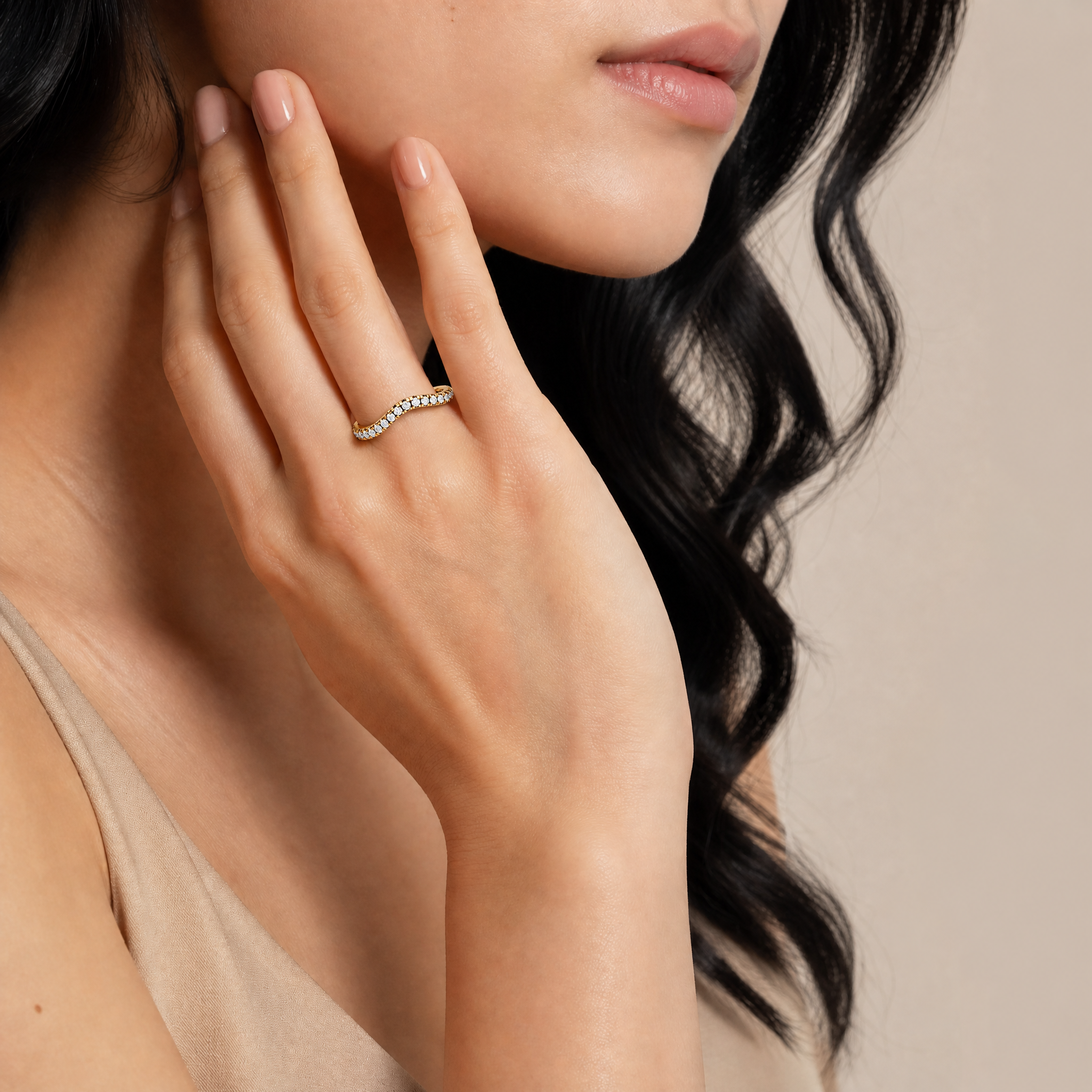 Model wearing Raul Diamonds yellow gold curved diamond wedding band with elegant bridal styling