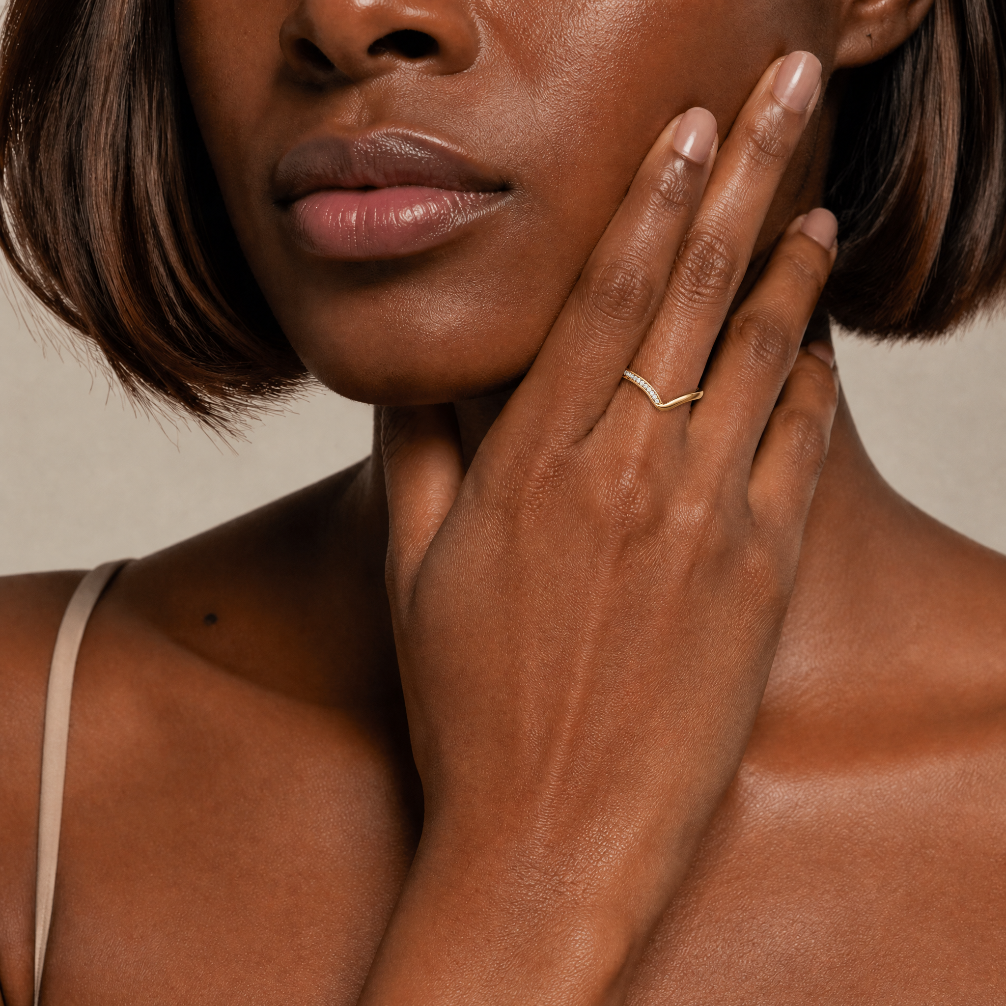 Female model wearing Raul Diamonds yellow gold baguette diamond wedding band with elegant luxury styling