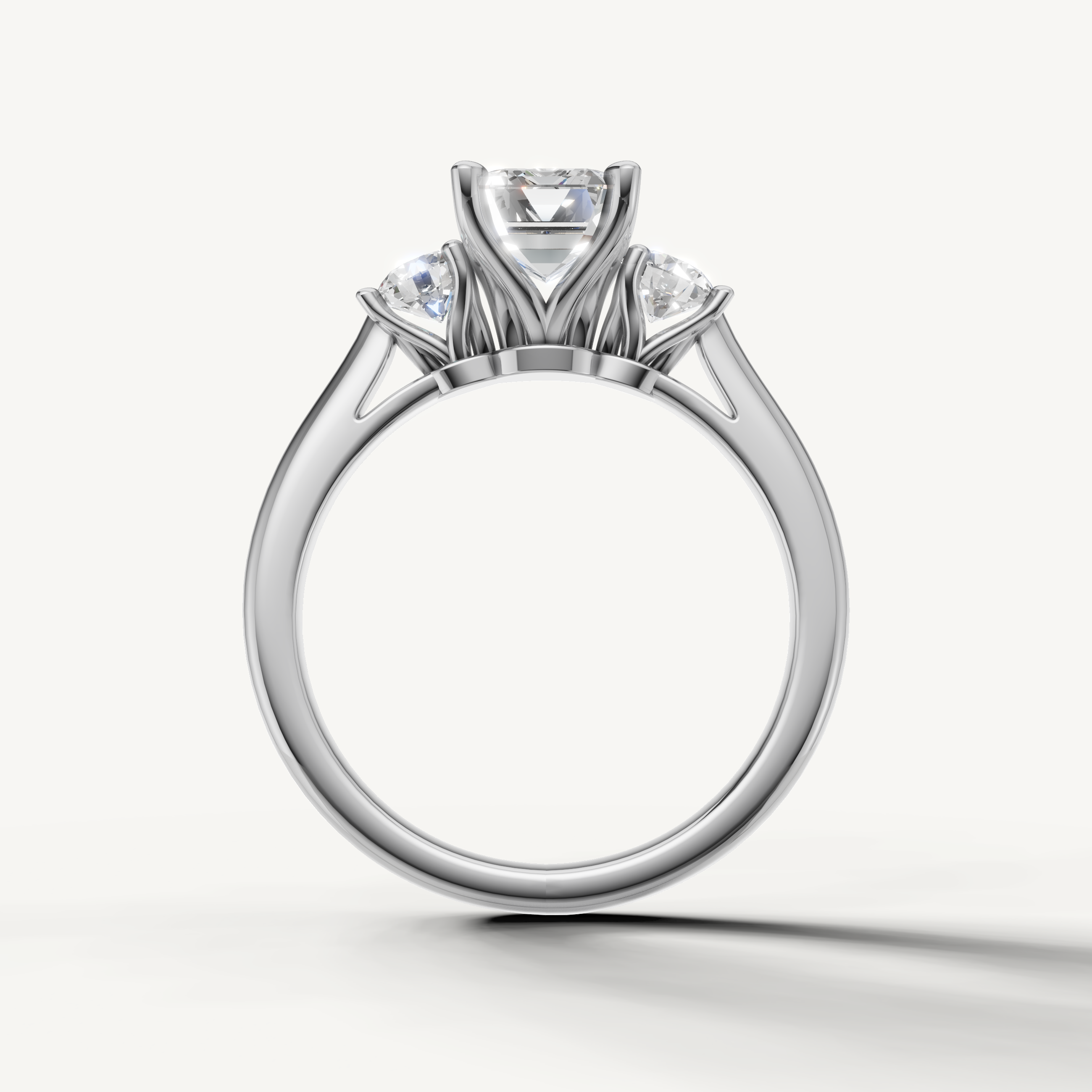 Classic emerald cut diamond engagement ring with round side stones in white gold