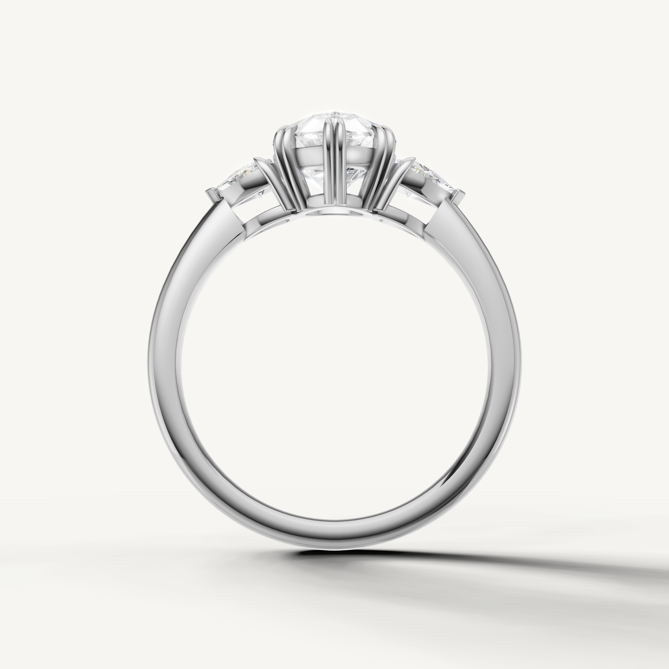 timeless pear shaped lab grown diamond ring with tapered trillion side stones