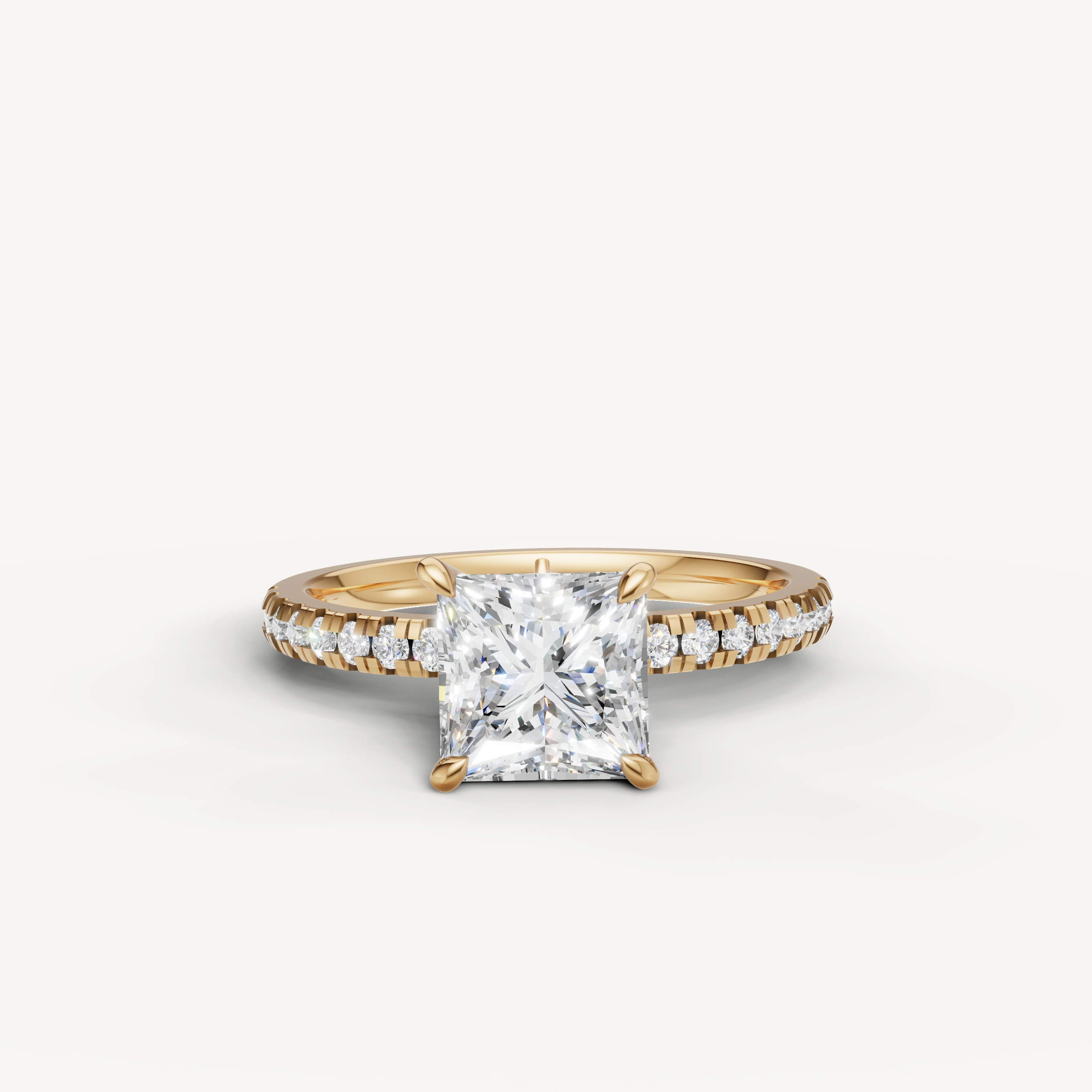 Raul Diamonds emerald cut engagement ring in 18k yellow gold featuring a brilliant pavé diamond band and hidden halo setting.