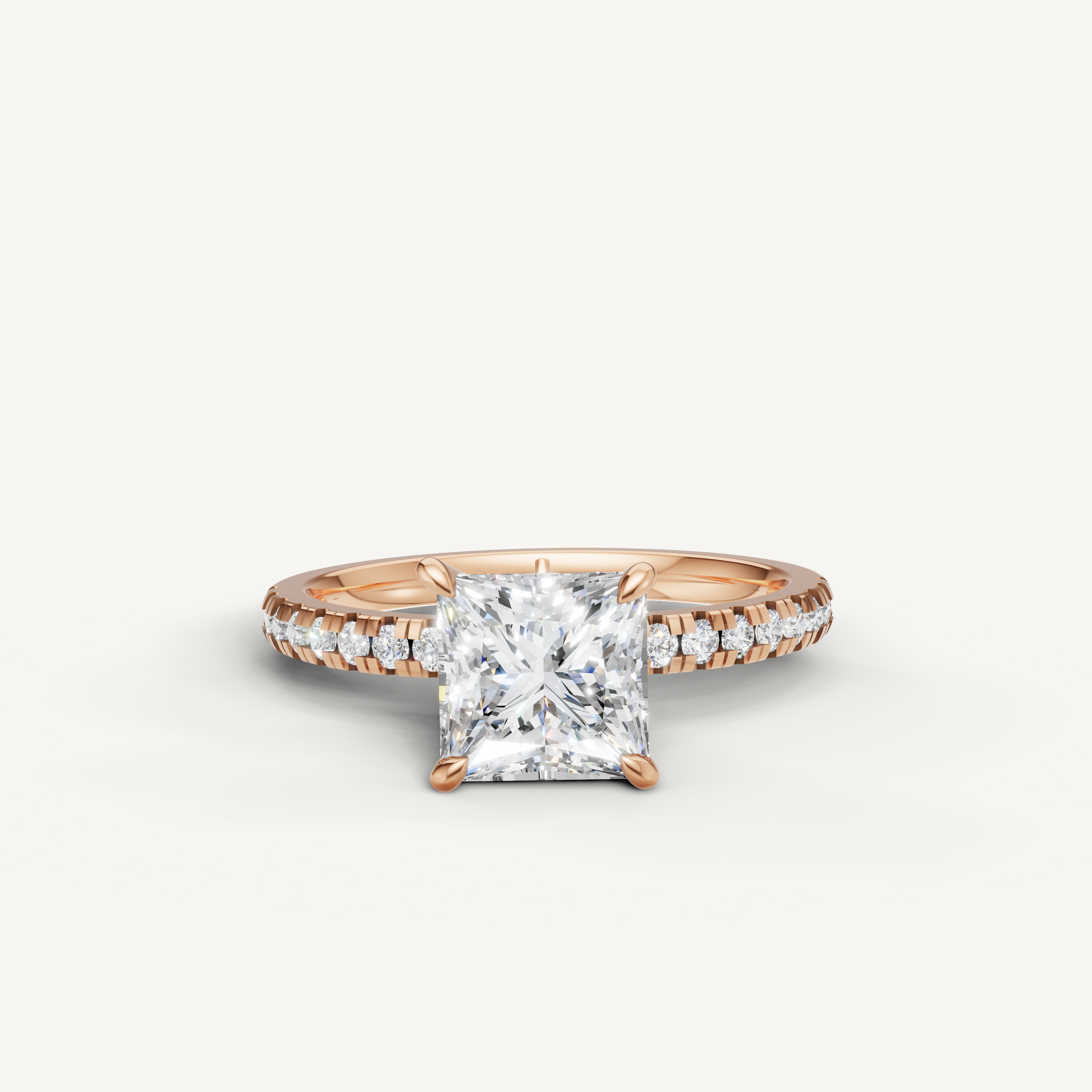 Romantic princess cut diamond engagement ring in rose gold with a pavé band, handcrafted by Raul Diamonds.