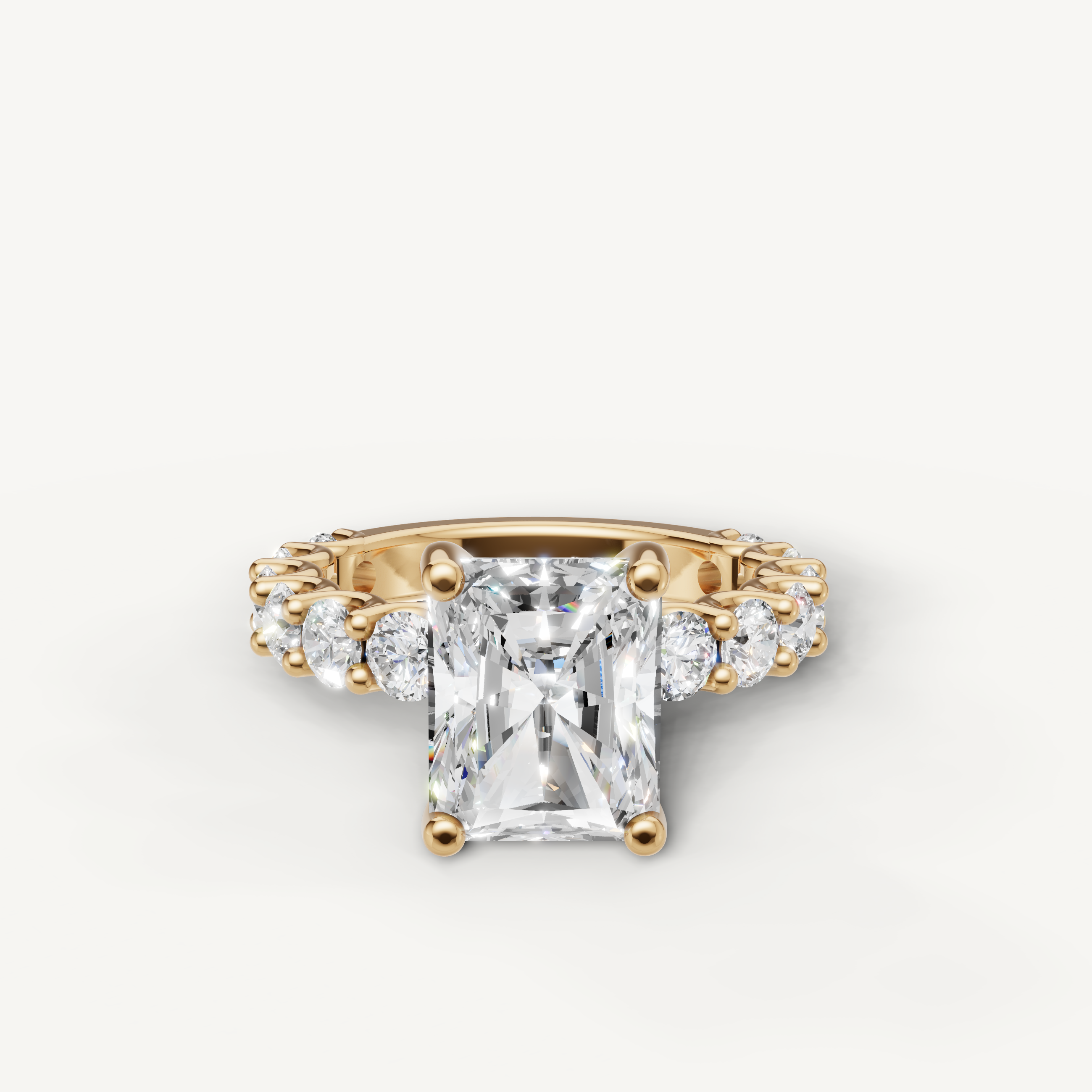 Radiant cut lab grown diamond engagement ring side view with shared prong eternity band in yellow gold