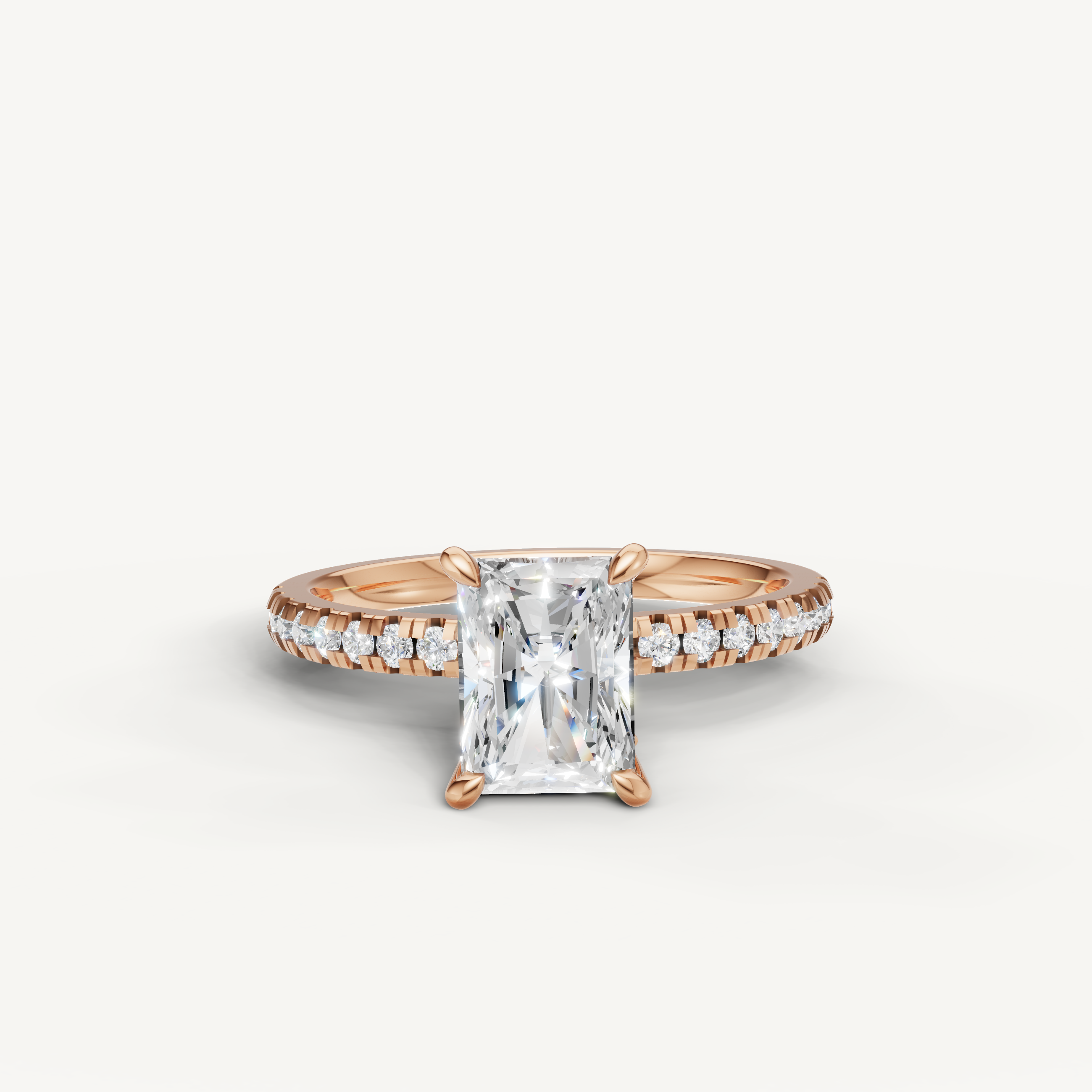 Romantic rose gold radiant cut diamond ring with a shimmering pavé band, perfect for a unique engagement proposal.