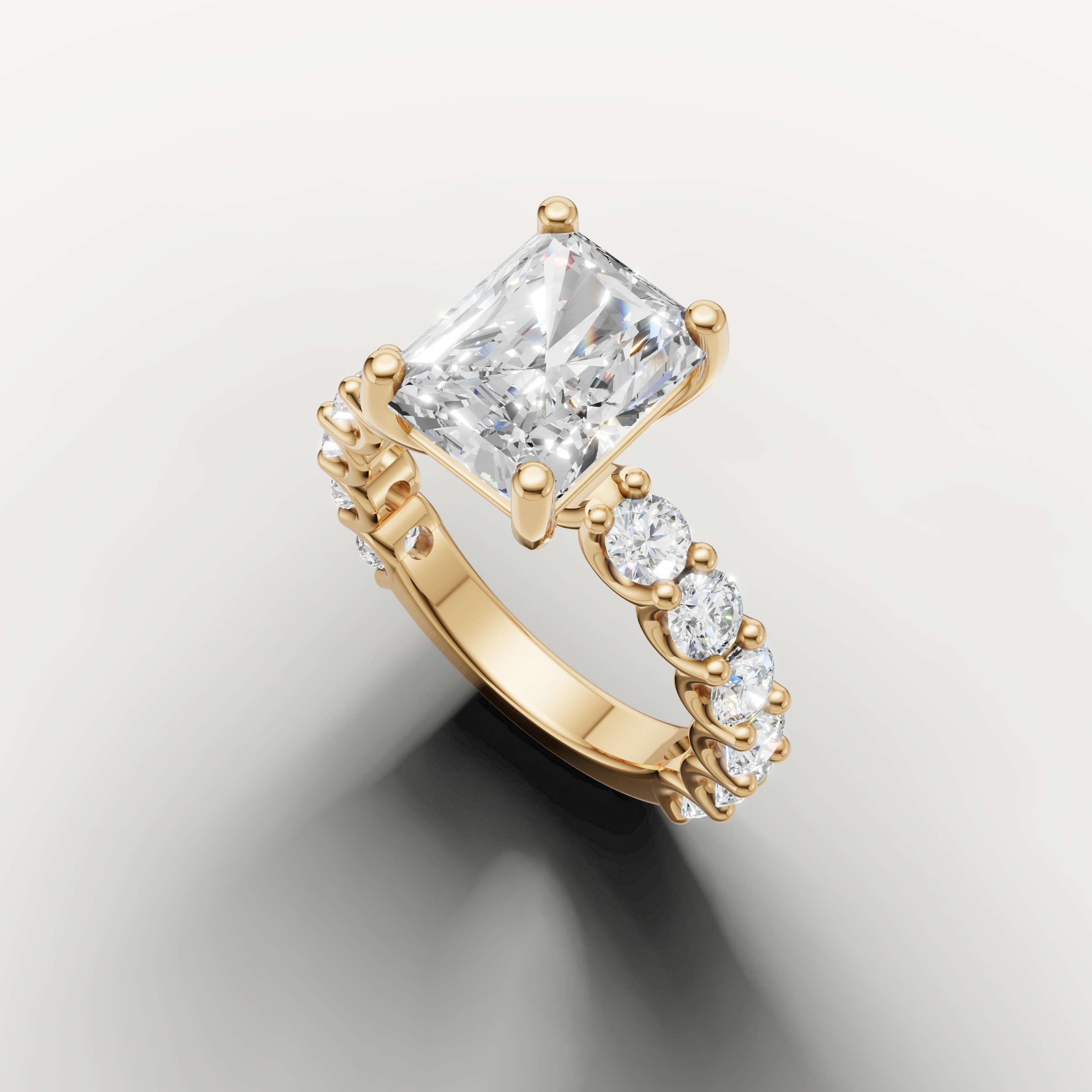 Radiant diamond ring with open gallery shared prong setting yellow gold side view